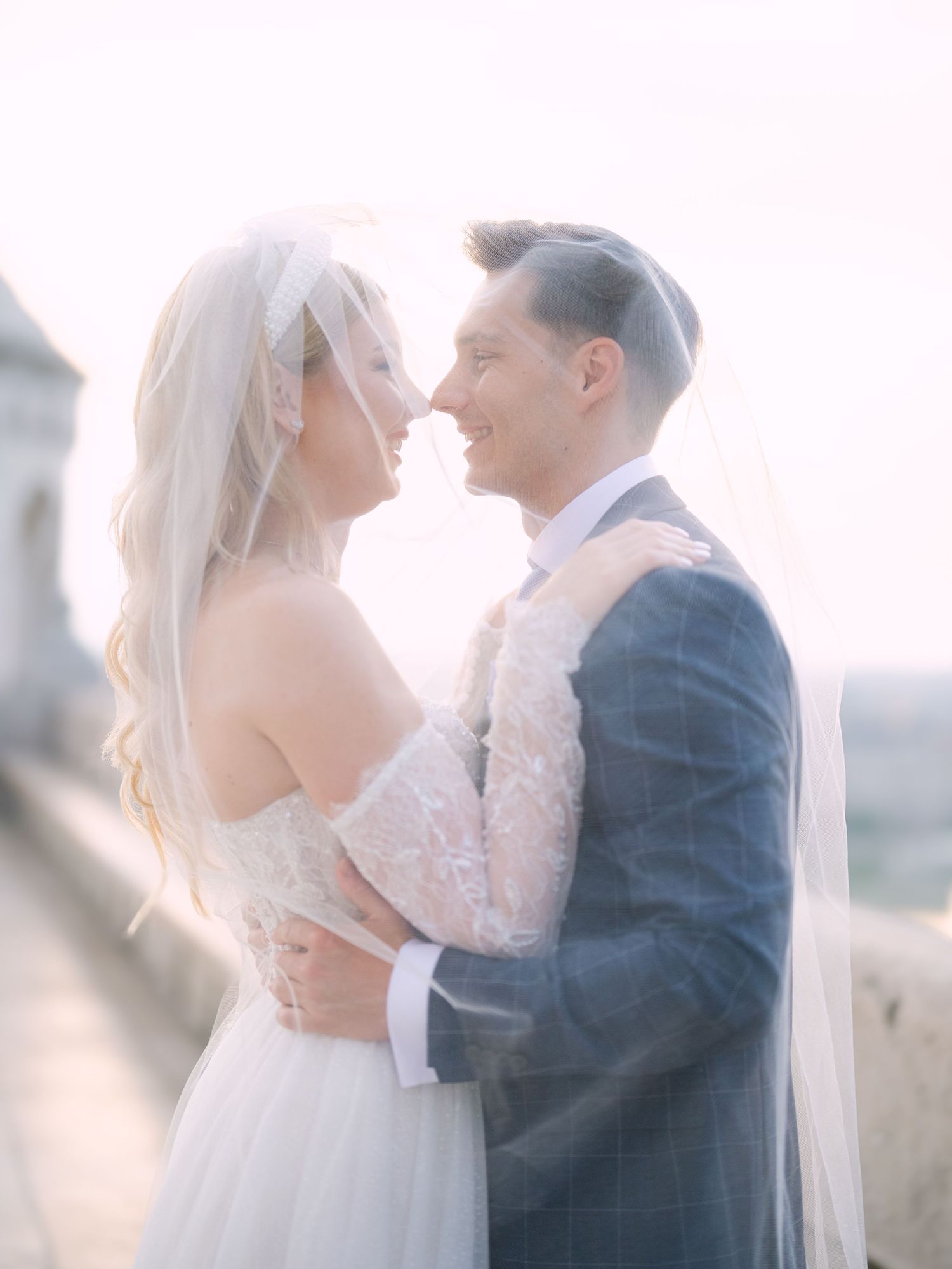 Captivating couple posing at sunrise on Fisherman’s Bastion in Budapest for a pre-wedding session, captured by Hang Pham Photography