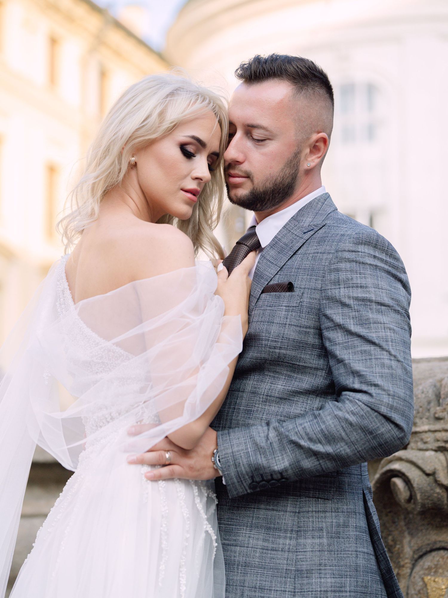 Dynamic couple posing at Prague Castle during a destination elopement, surrounded by historic architecture, captured by Hang Pham