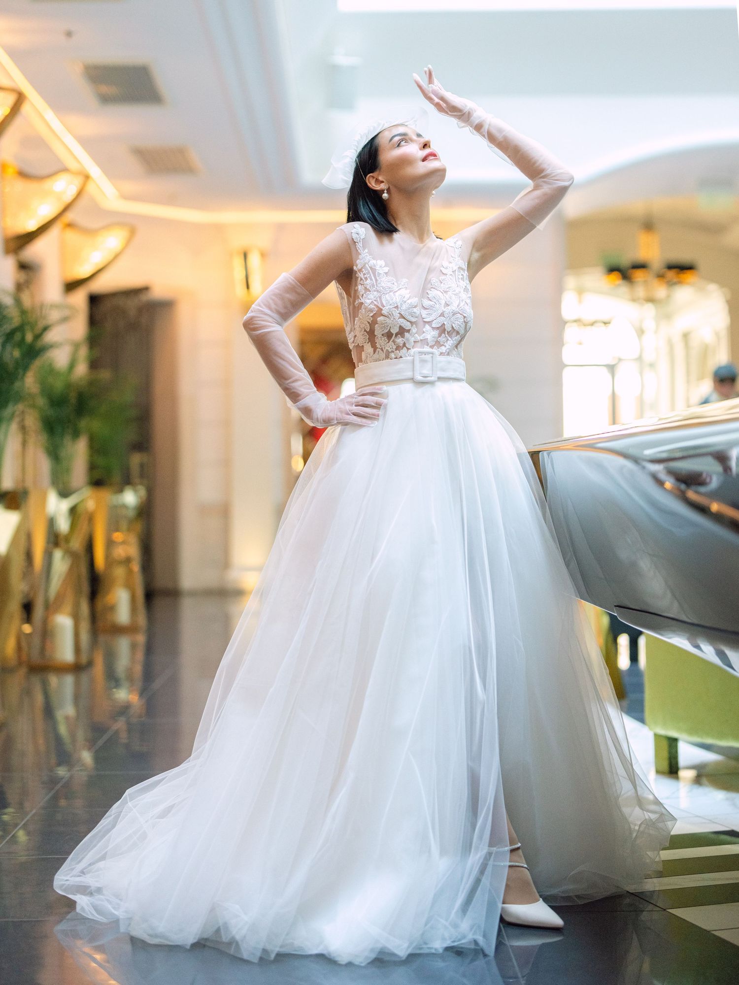 Elegant bride in a Nagy Agota wedding dress posing at Aria Hotel Budapest during a destination wedding, captured by Hang Pham Photography