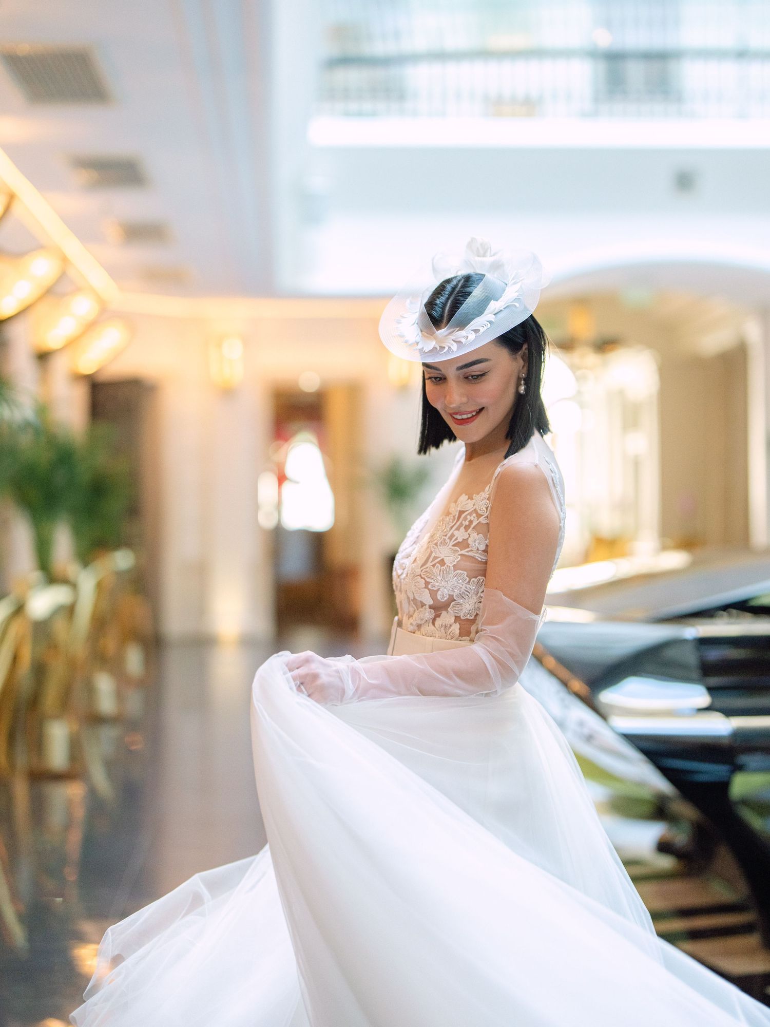 Elegant bride in a Nagy Agota wedding dress posing at Aria Hotel Budapest during a destination wedding editorial, captured by Hang Pham