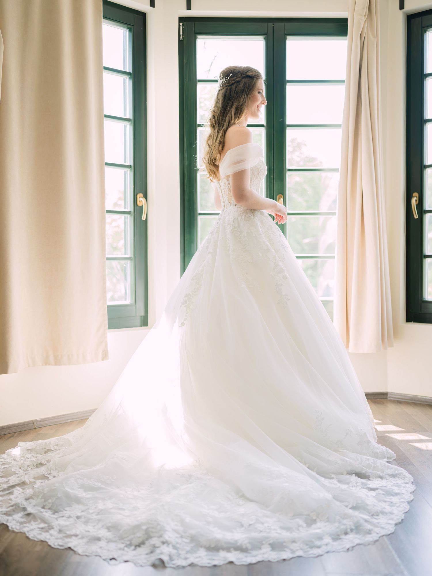 Cheerful bride posing elegantly for a stunning bridal portrait in Budapest, captured during an intimate wedding with timeless charm
