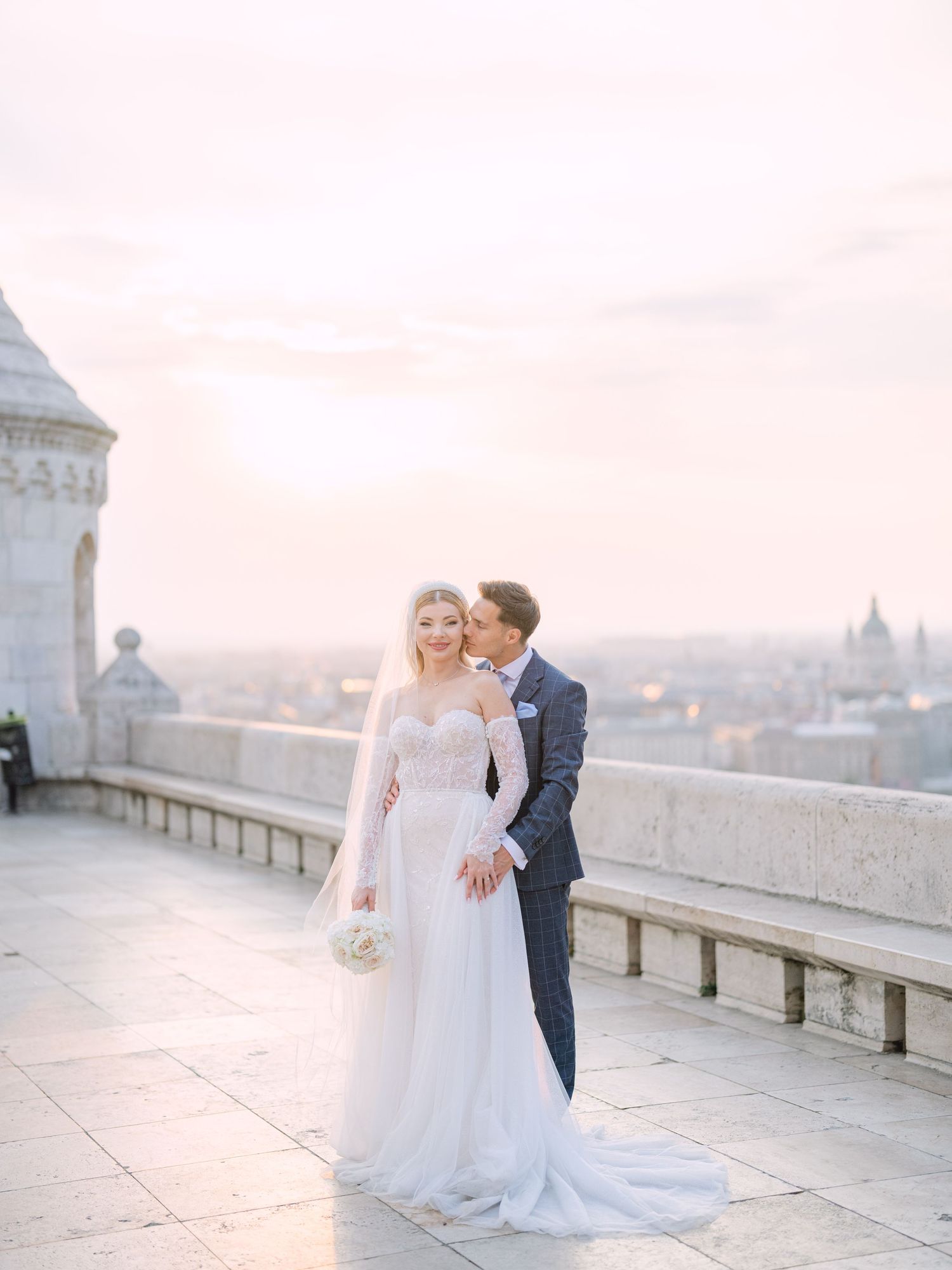 Captivating couple posing at sunrise on Fisherman’s Bastion in Budapest for a pre-wedding session, captured by Hang Pham Photography