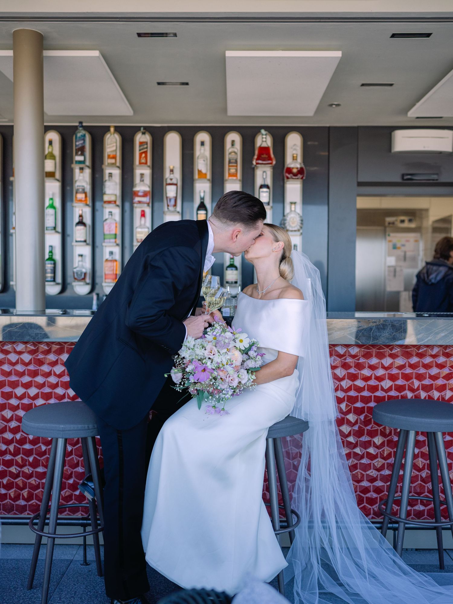 High-end couple posing for a creative wedding photoshoot at White Raven Skybar atop Hilton Budapest, featuring stunning city skyline views