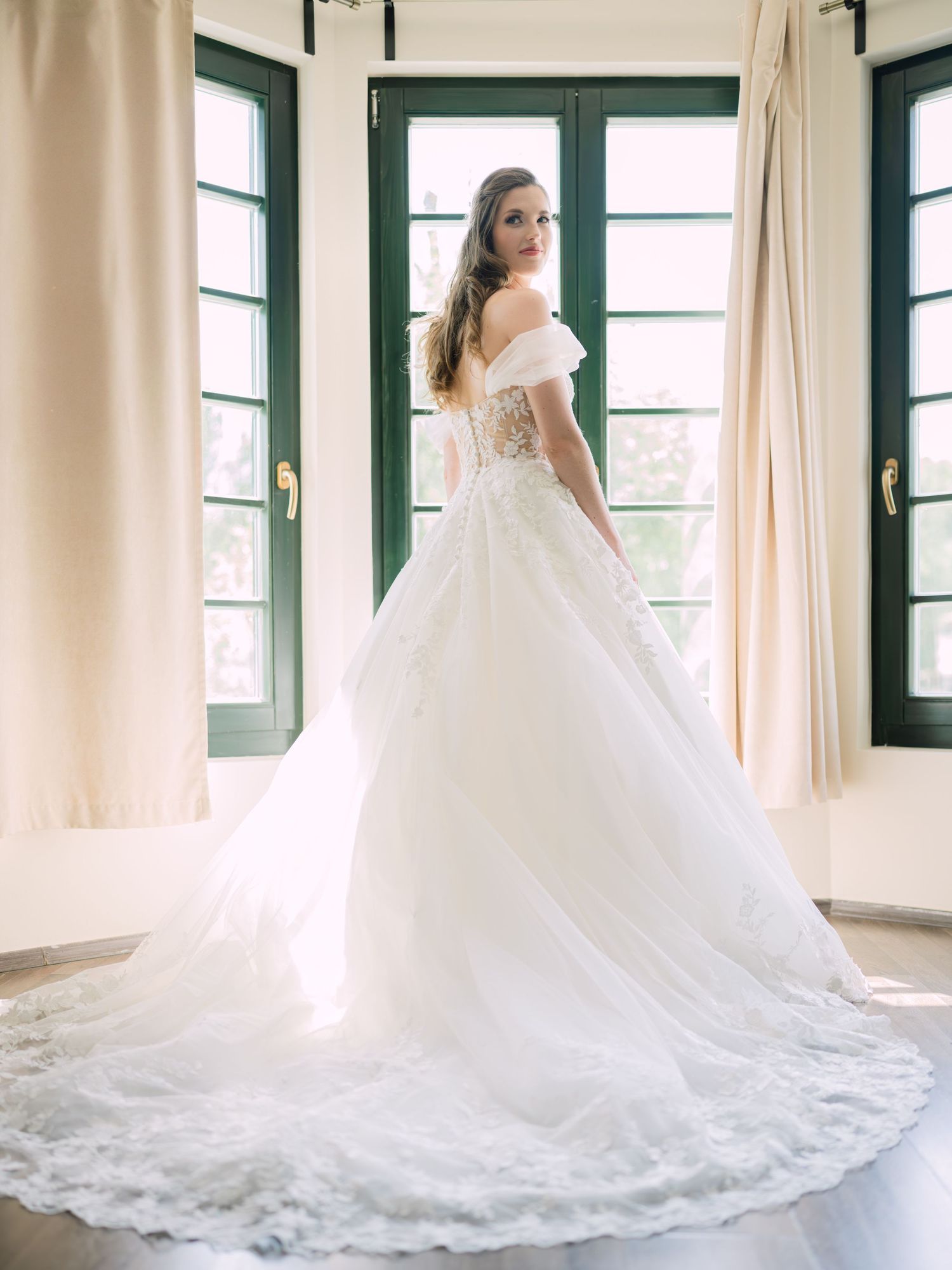 Cheerful bride posing elegantly for a stunning bridal portrait in Budapest, captured during an intimate wedding with timeless charm