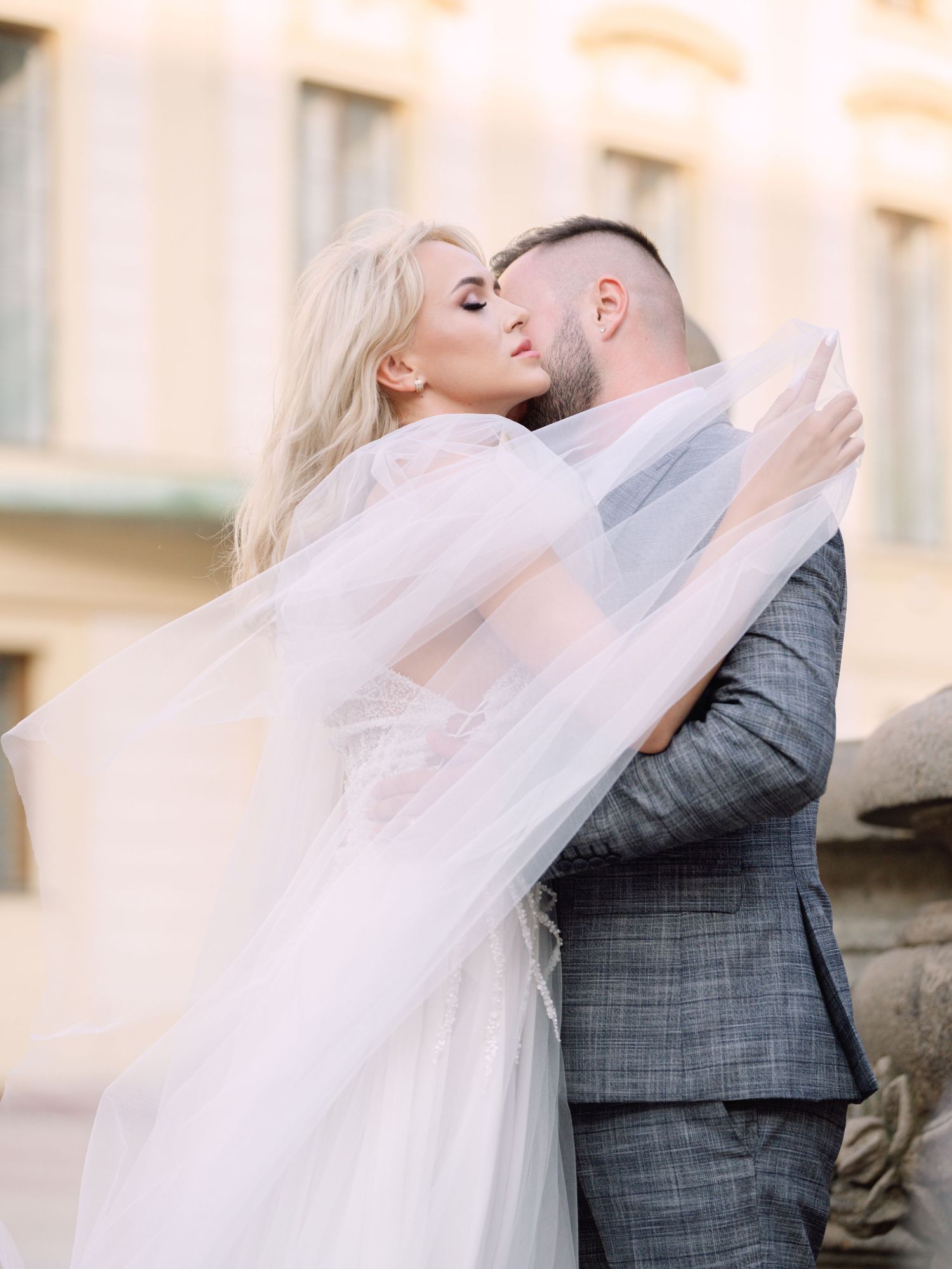 Dynamic couple posing at Prague Castle during a destination elopement, surrounded by historic architecture, captured by Hang Pham