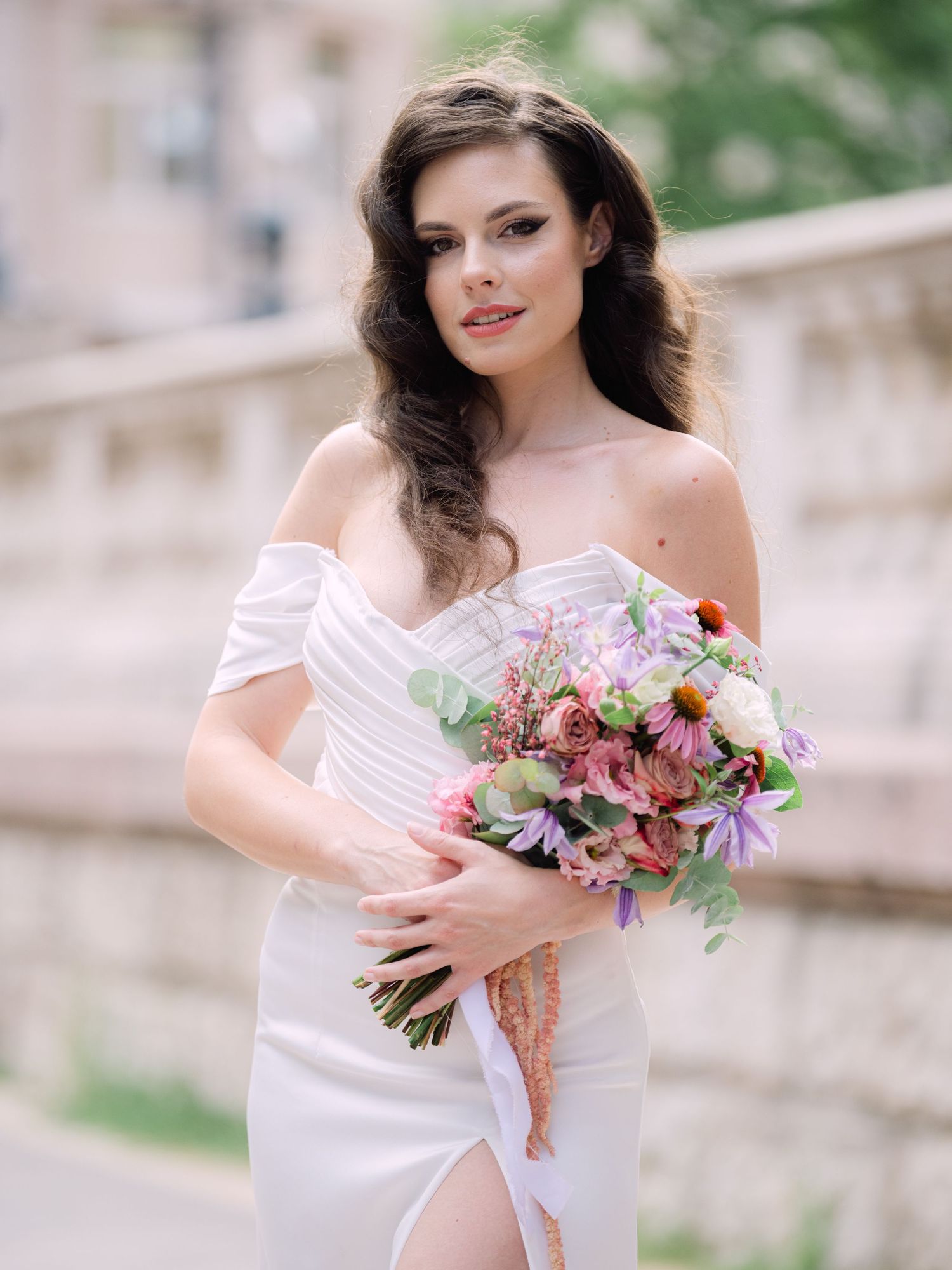 Captivating bride in a Leya Couture dress posing near St. Peter’s Basilica in Budapest for a wedding editorial by Hang Pham Photography