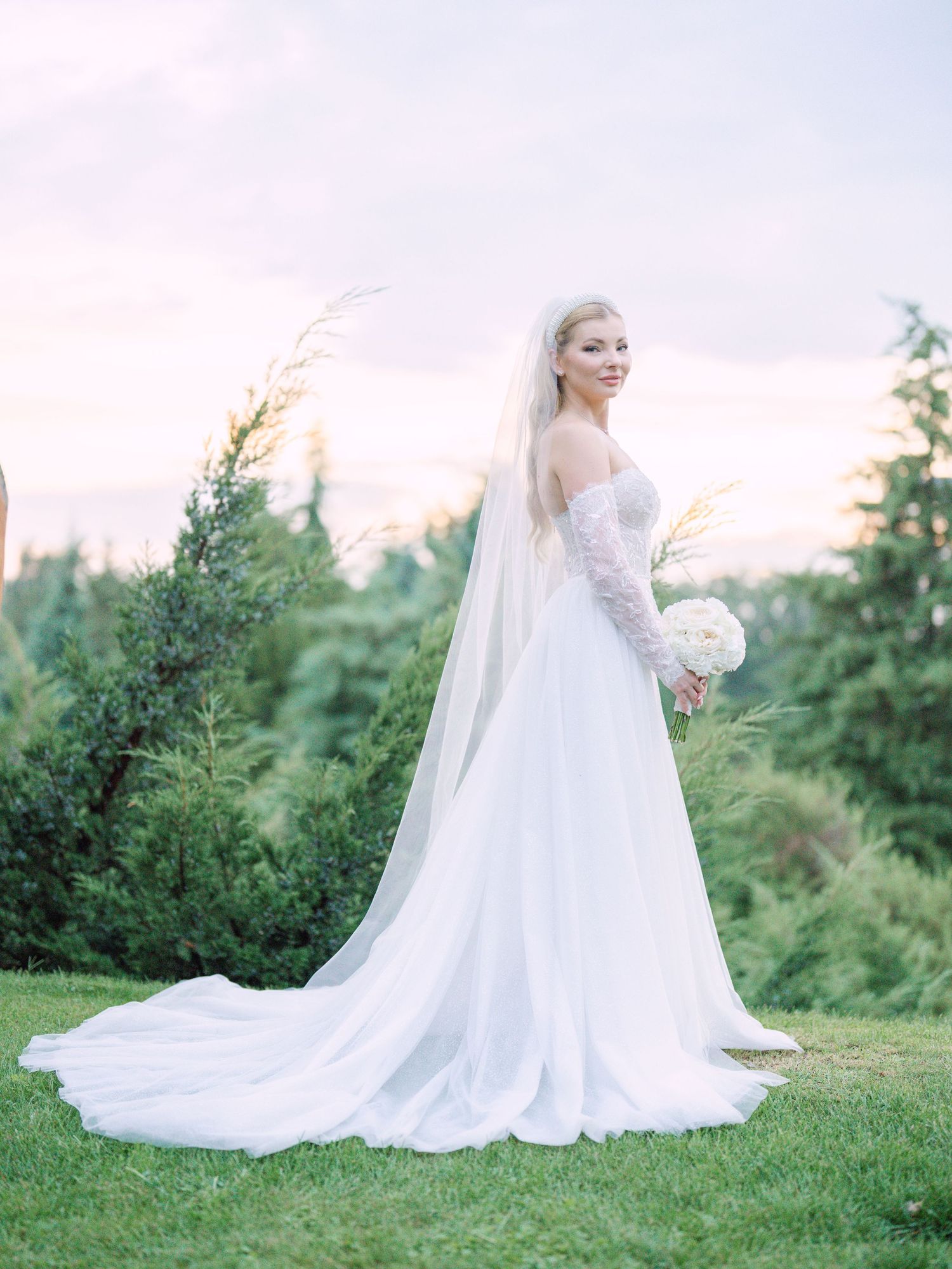 Elegant bride in a La Mariée wedding dress posing during a golden hour sunset in Napkor, captured for a creative wedding session by Hang