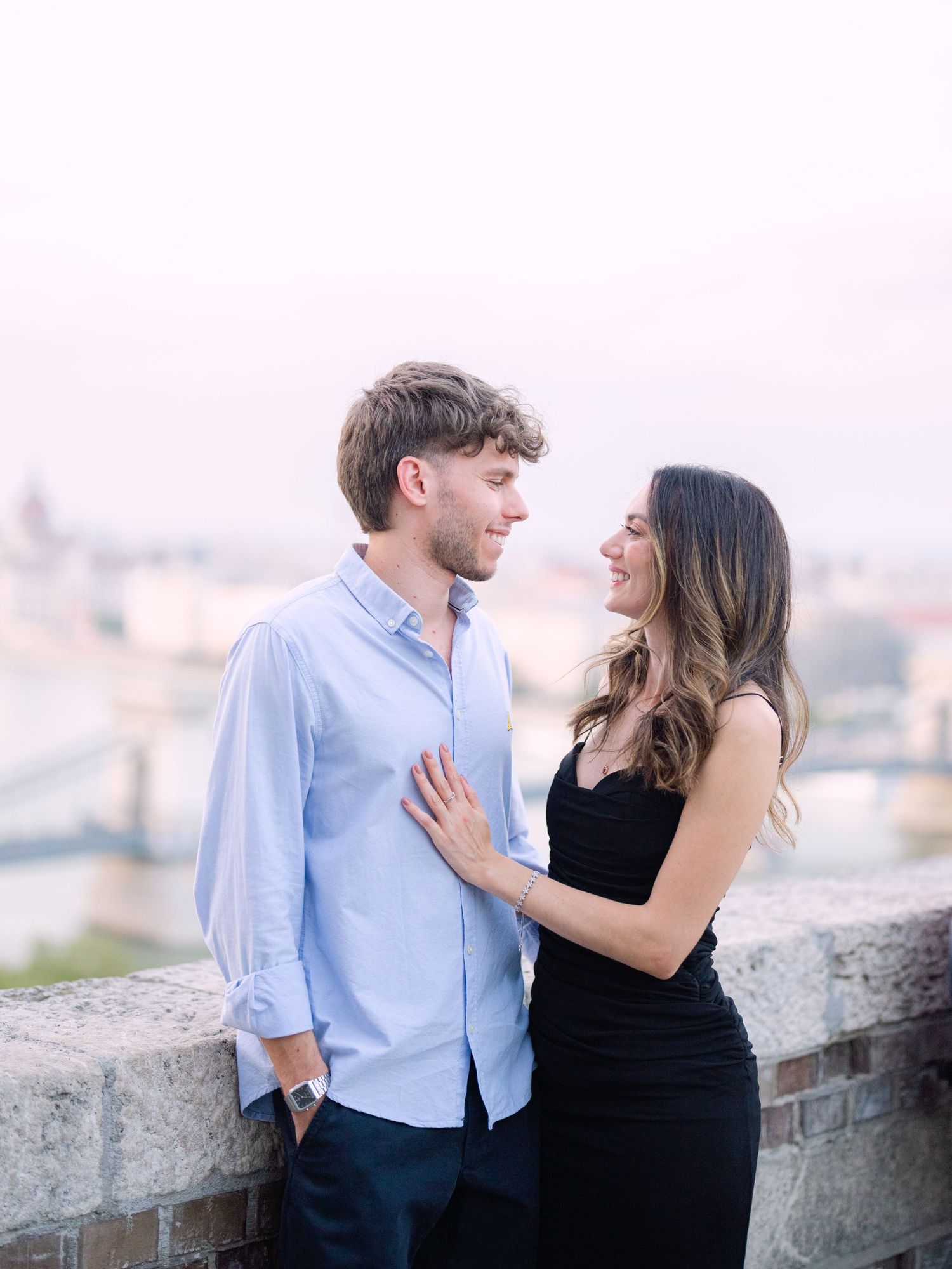 Elegant couple posing around Buda Castle in Budapest during a romantic portrait session, beautifully captured by Hang Pham Photography