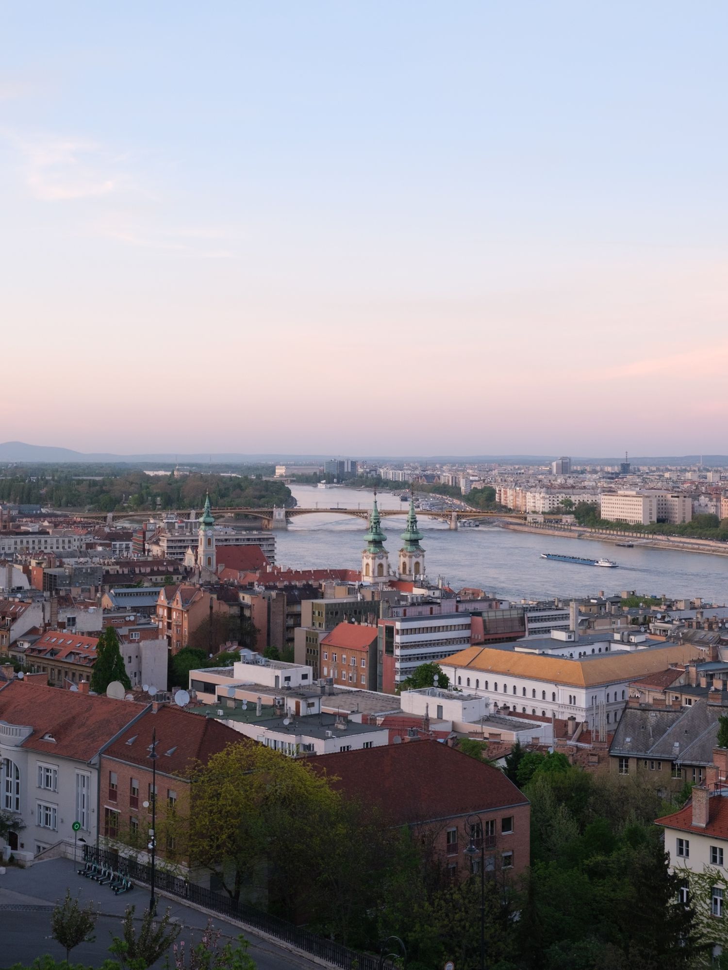 Stunning view of Budapest from Fisherman’s Bastion at sunset, showcasing the city’s iconic skyline bathed in golden hour light