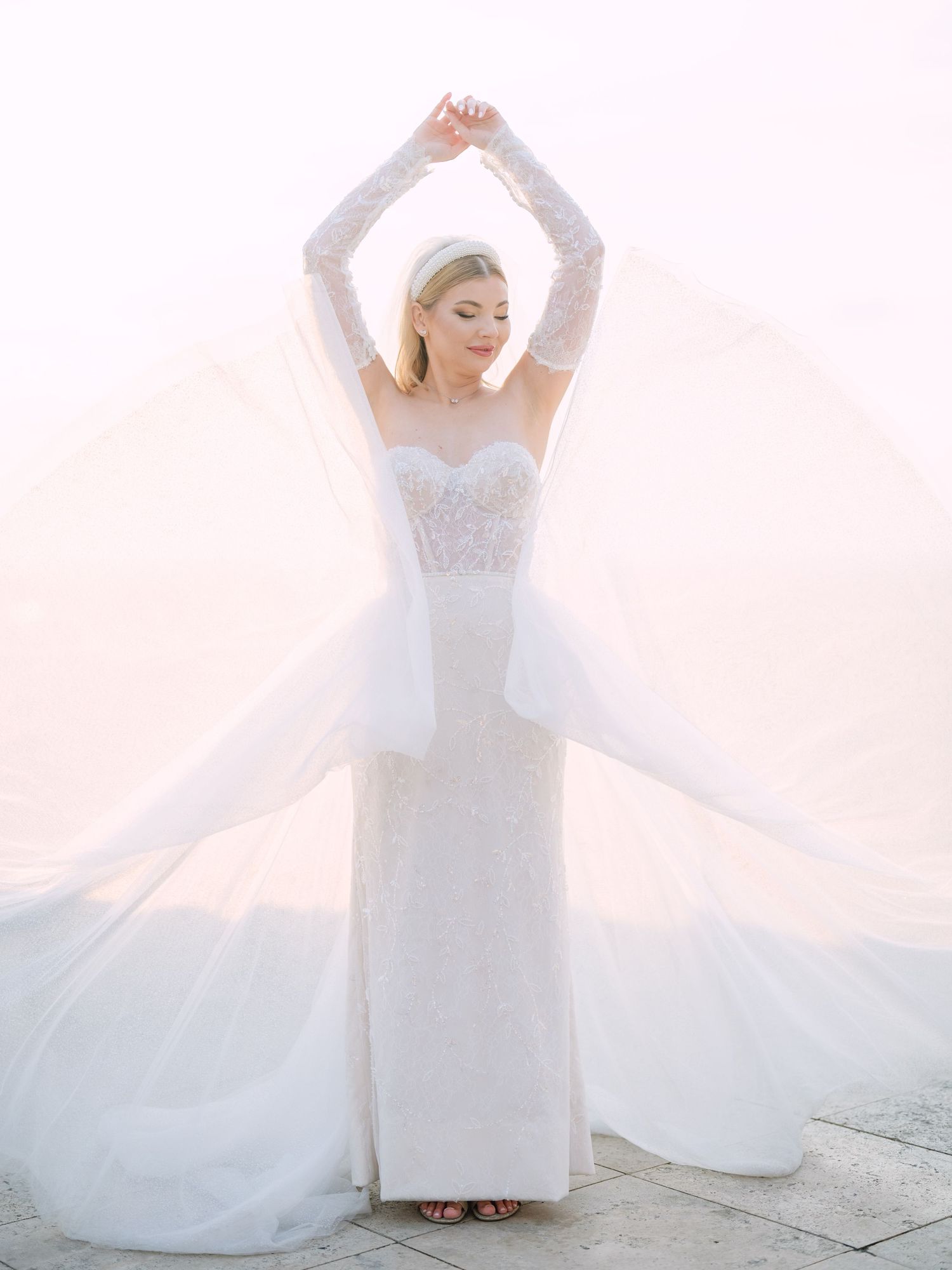 Captivating bride in a La Mariée dress posing at sunrise on Fisherman’s Bastion in Budapest during a pre-wedding session by Hang Pham