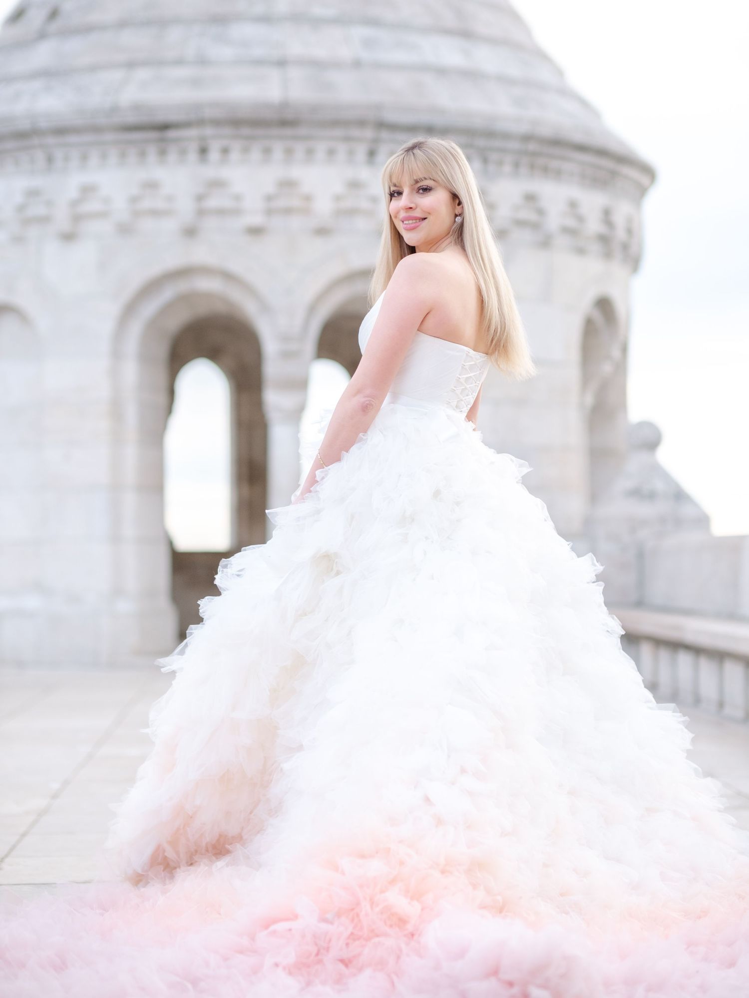 Graceful bride in Eva Halasz couture posing at Fisherman’s Bastion during a romantic elopement shoot, captured by Hang Pham Photography