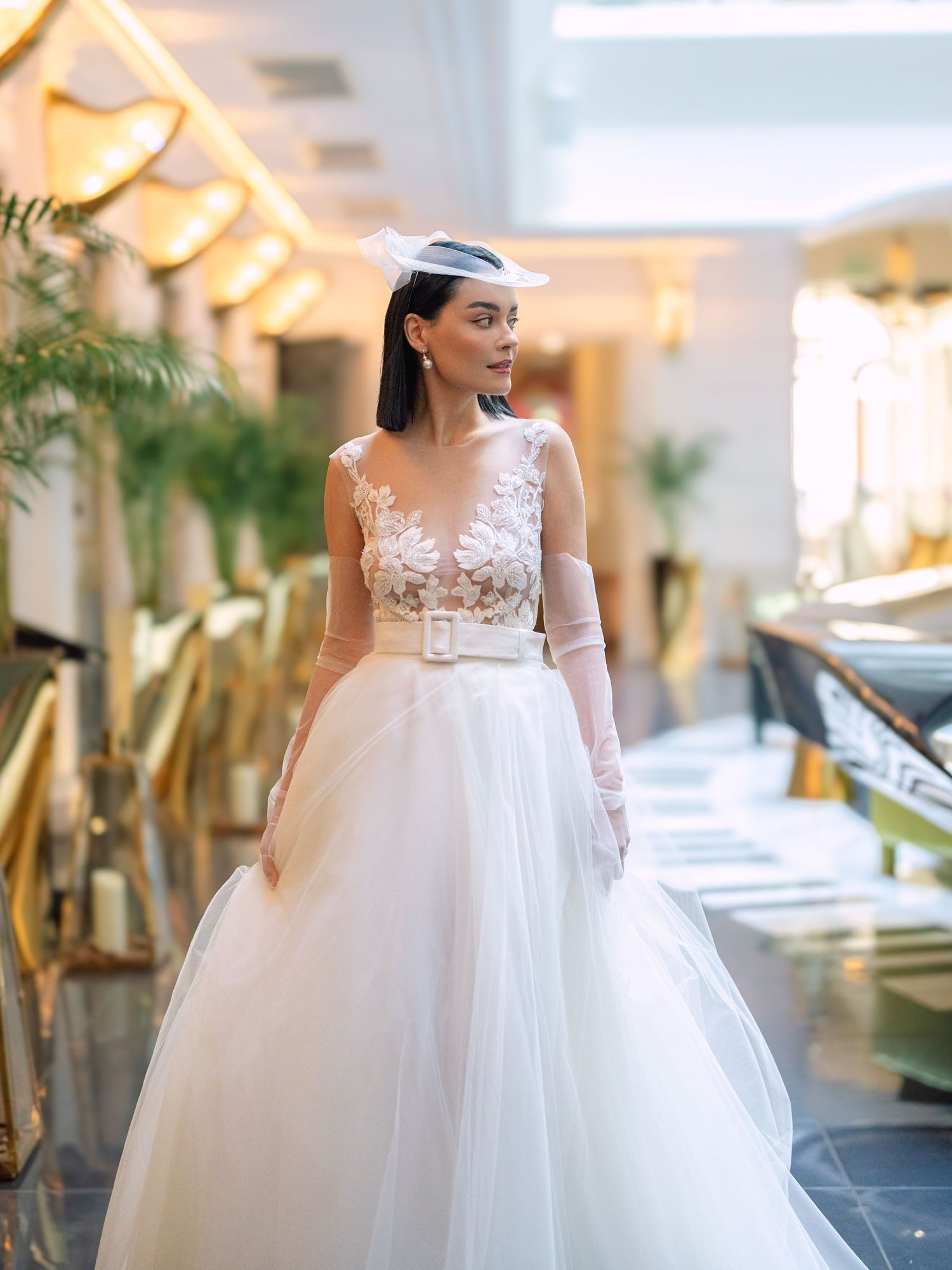 Elegant bride in a Nagy Agota wedding dress posing at Aria Hotel Budapest during a destination wedding editorial, captured by Hang Pham