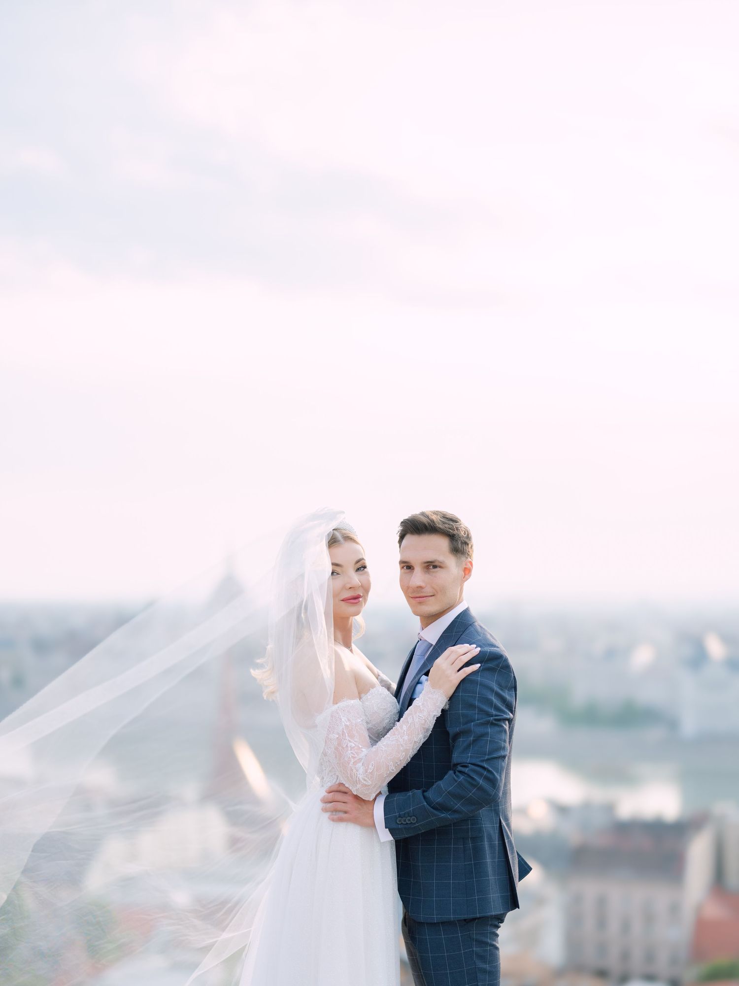 Captivating couple posing at sunrise on Fisherman’s Bastion in Budapest for a pre-wedding session, captured by Hang Pham Photography