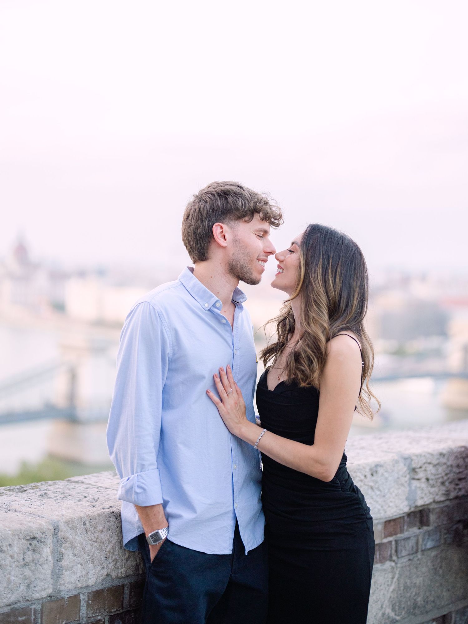 Elegant couple posing around Buda Castle in Budapest during a romantic portrait session, beautifully captured by Hang Pham Photography
