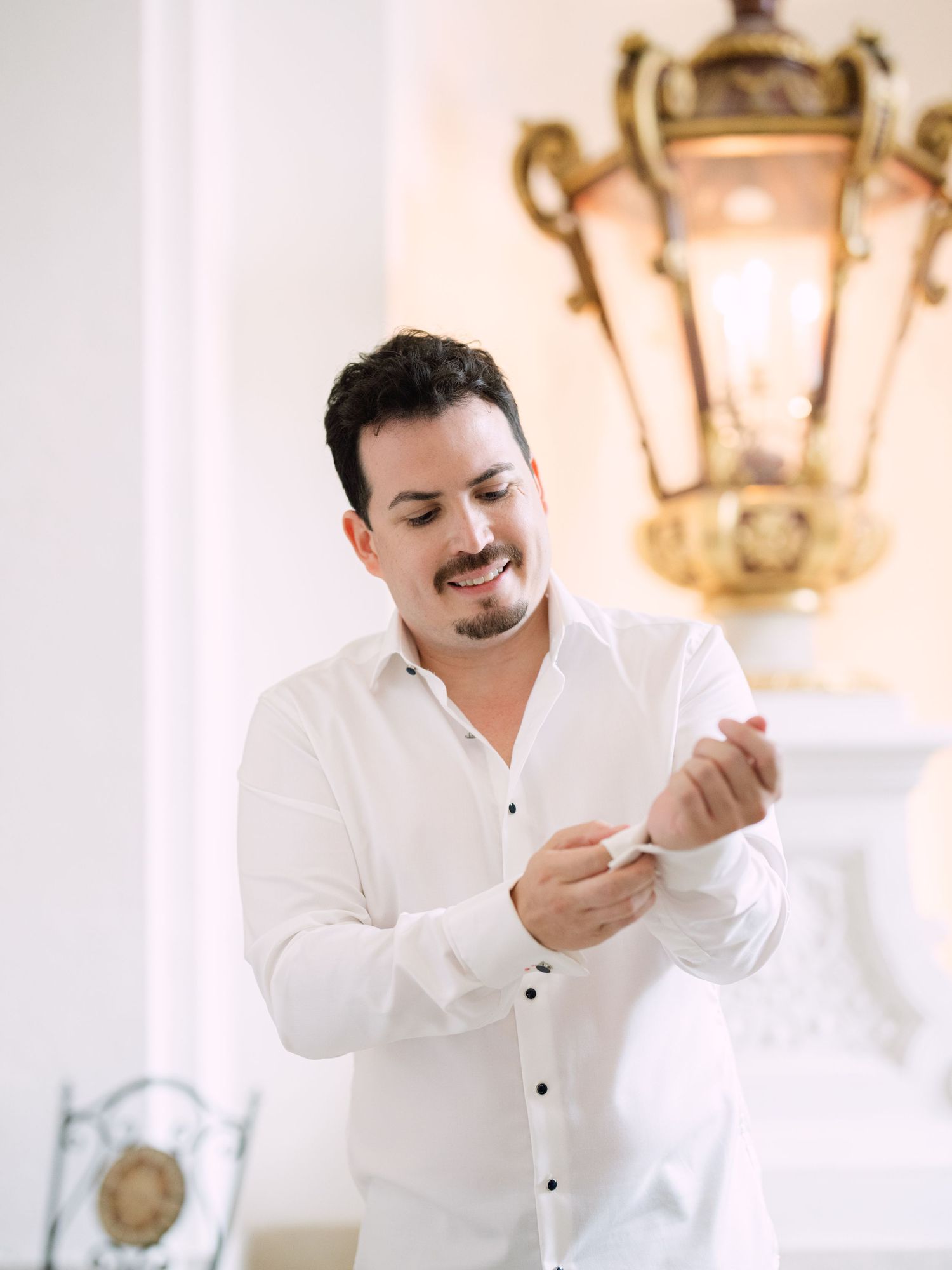 Groom preparing for his wedding day in an elegant Austrian castle, surrounded by timeless architecture and luxurious details