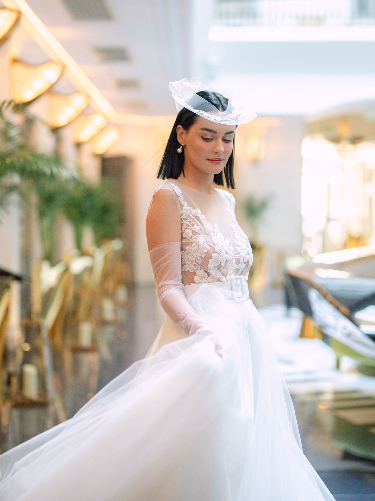 Elegant bride in a Nagy Agota wedding dress posing at Aria Hotel Budapest during a destination wedding editorial, captured by Hang Pham