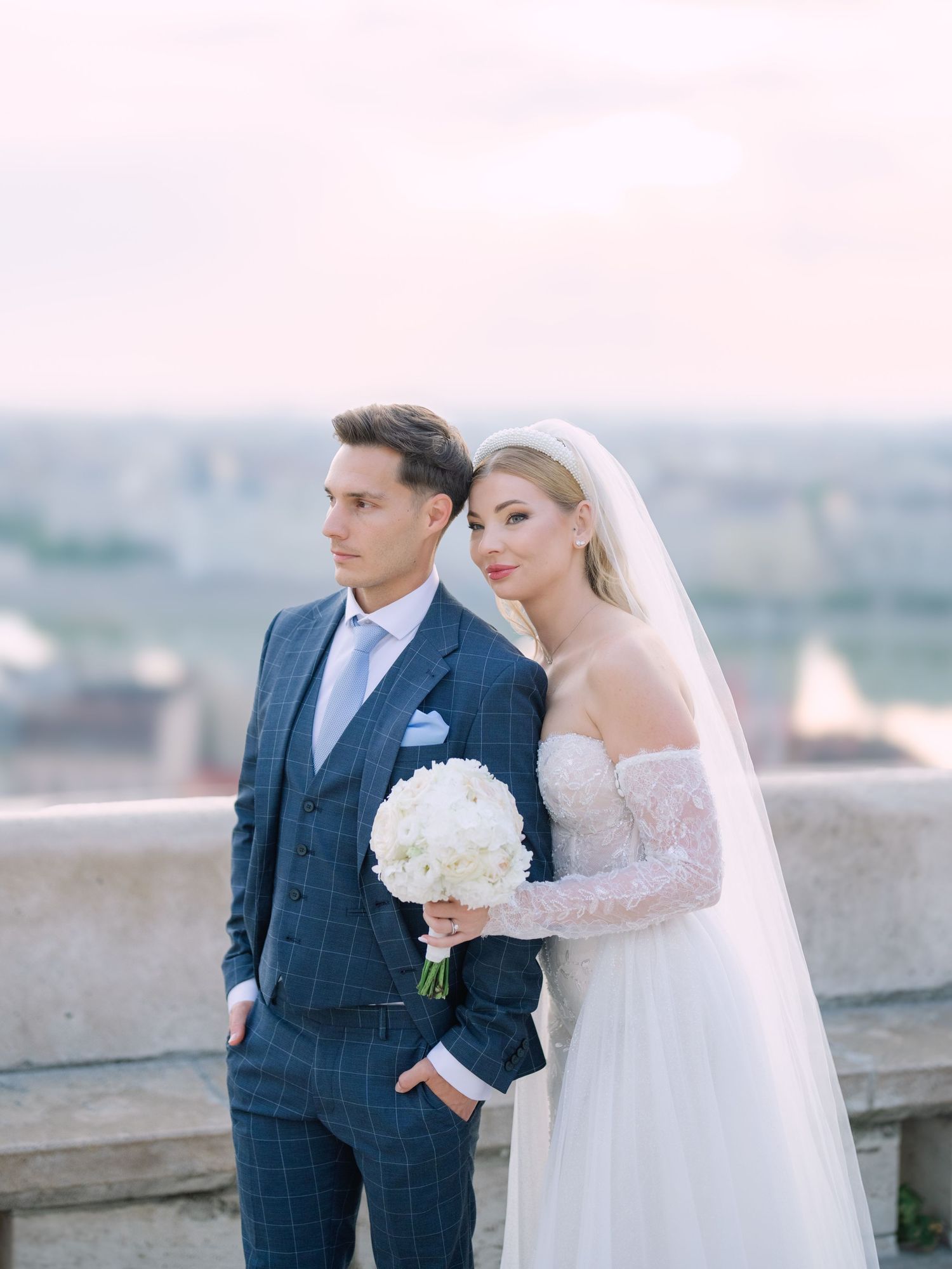 Romantic couple posing at sunrise on Fisherman’s Bastion in Budapest for a pre-wedding session, beautifully captured by Hang Pham
