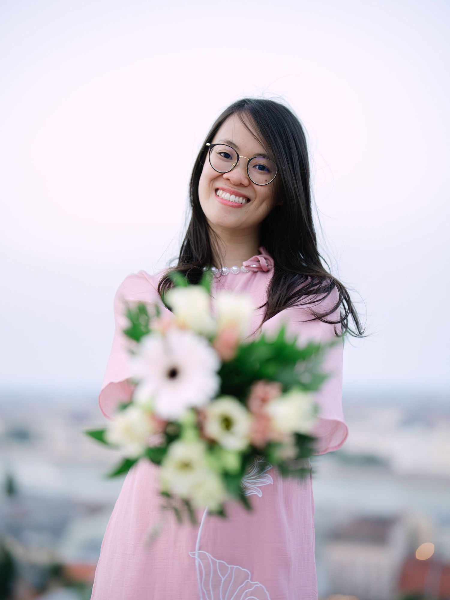 Charming bride posing during a scenic engagement shoot with breathtaking views of Budapest from Fisherman’s Bastion at golden hour