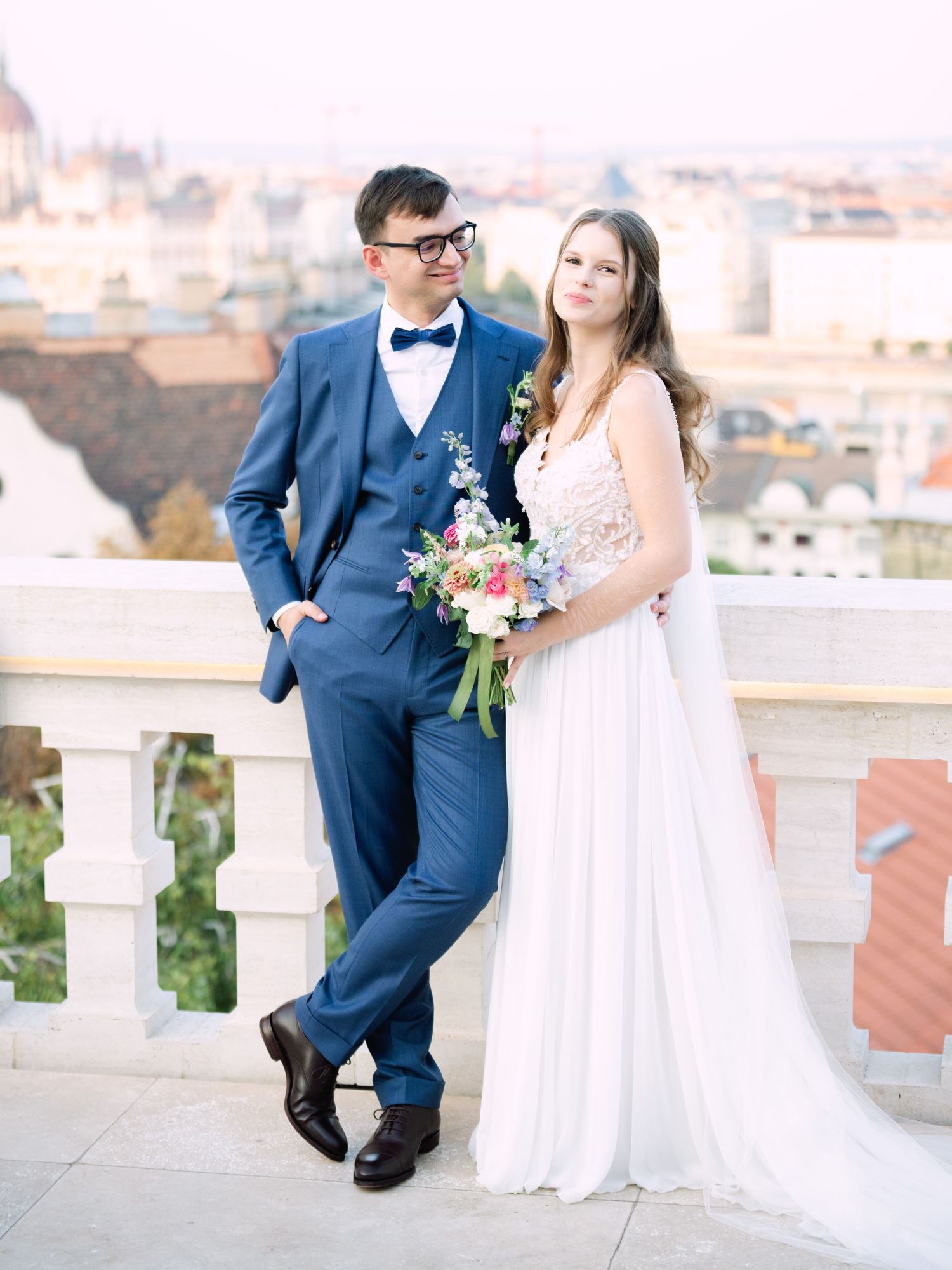 Creative couple' portraits on the Panorama Terrace at Aranybástya Restaurant in Budapest during an intimate destination wedding by Hang Pham