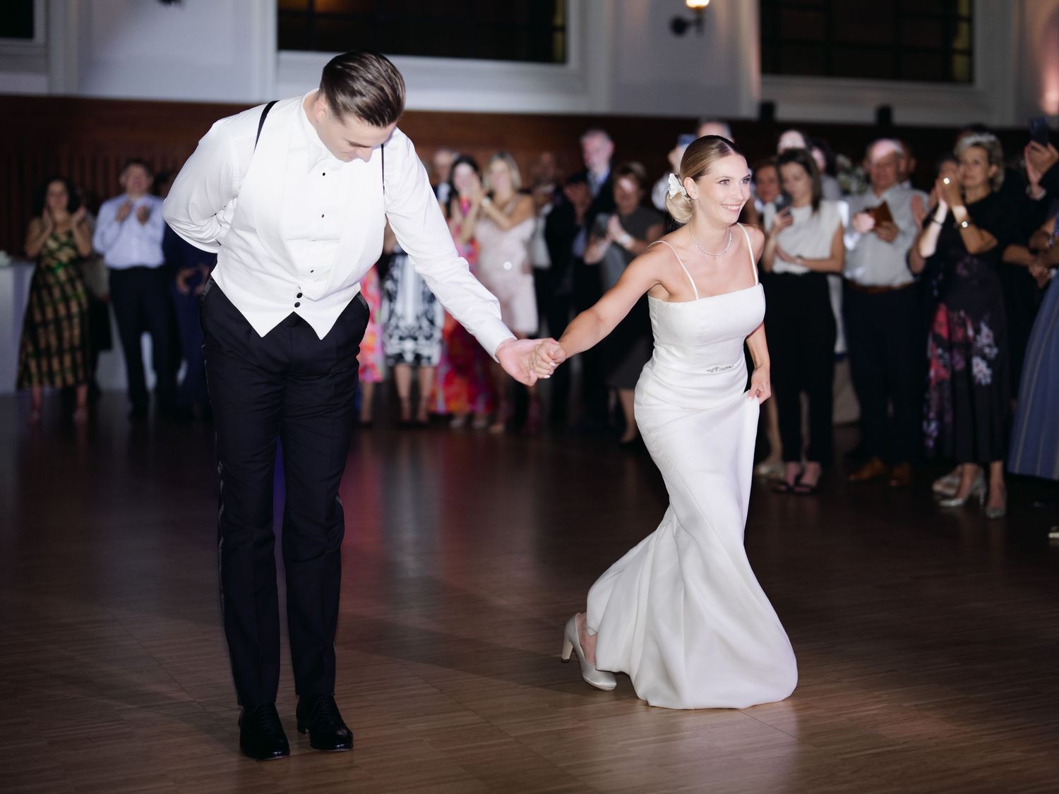 Elegant high-society couple sharing their wedding first dance at the luxurious Buda Castle Royal Riding Hall, surrounded by timeless glamour