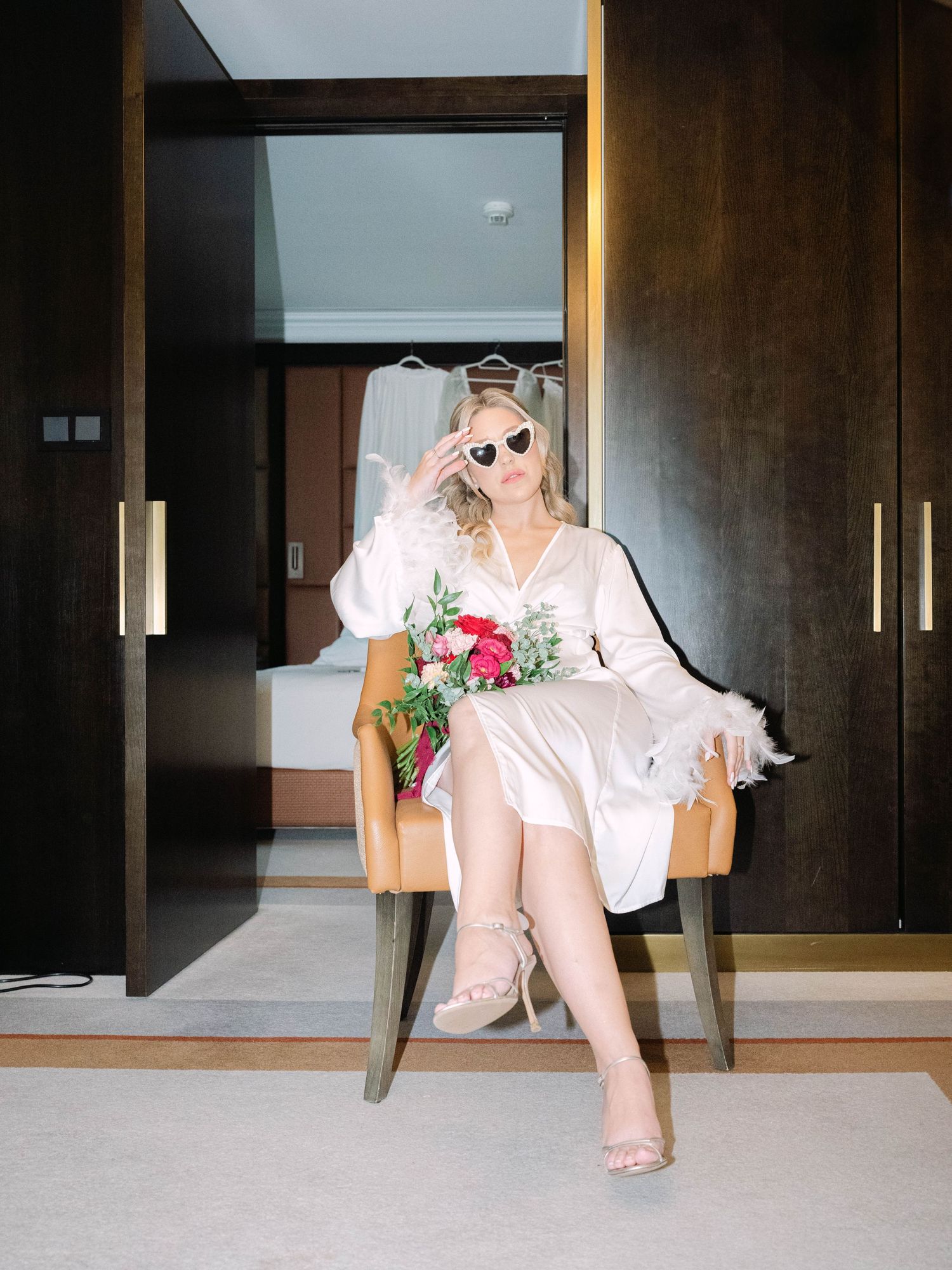 Creative flash shots of a captivating bride in a Hilton Hotel suite in Budapest, styled for an intimate luxury destination wedding