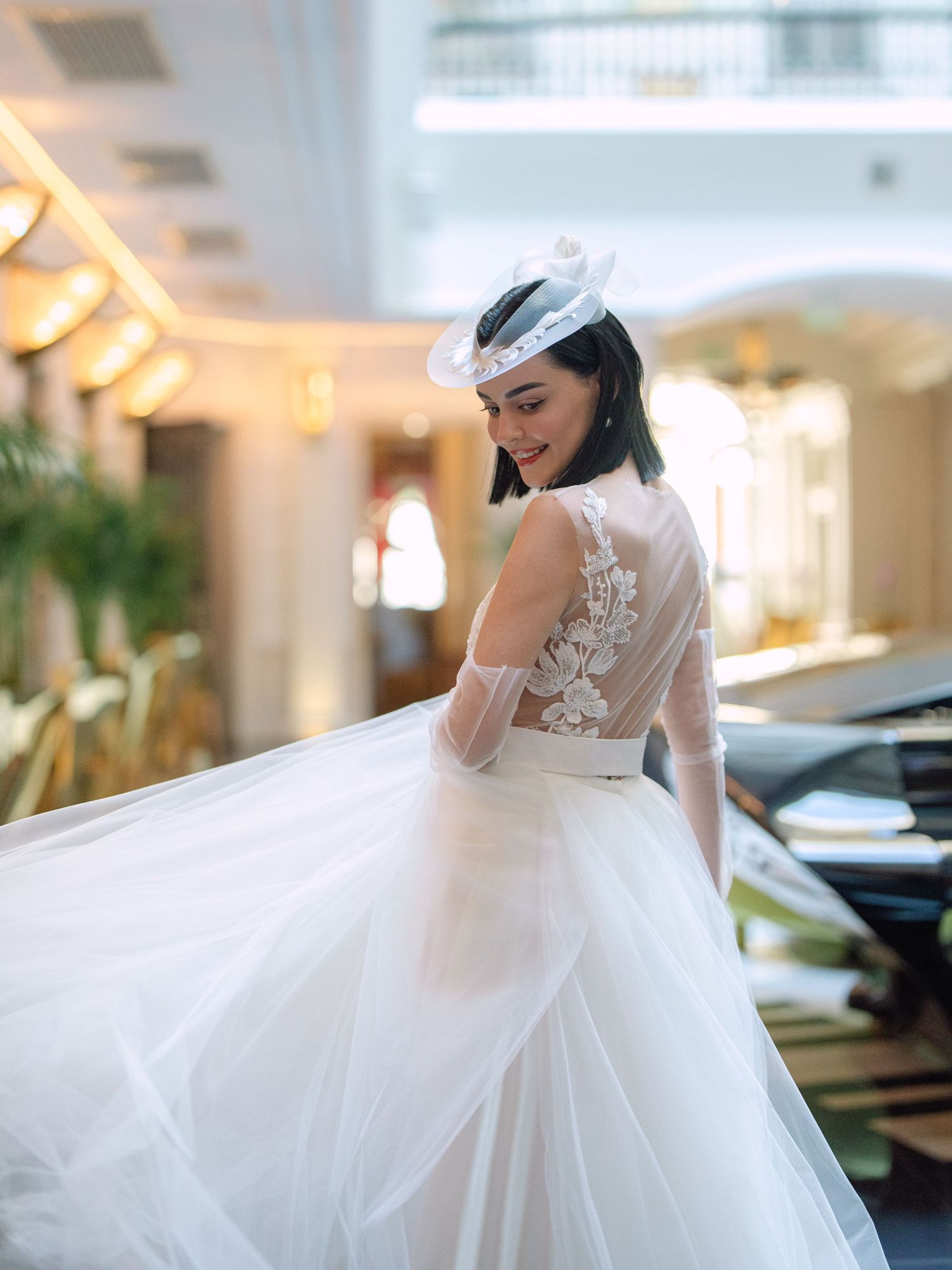Elegant bride in a Nagy Agota wedding dress posing at Aria Hotel Budapest during a destination wedding editorial, captured by Hang Pham