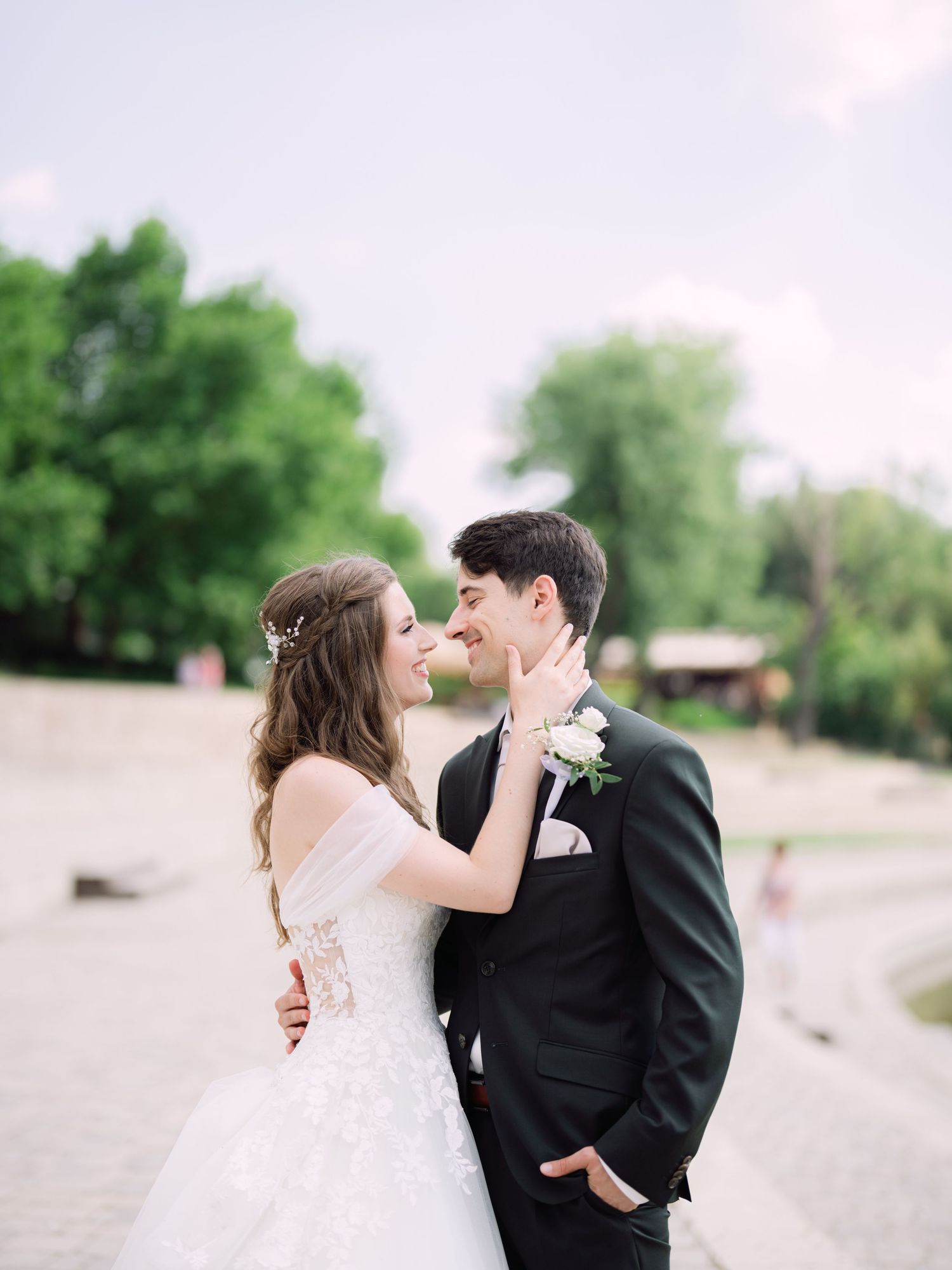 Cheerful couple posing at Kopaszi Gat in Budapest during a romantic pre-wedding session in natural light for an intimate Budapest wedding
