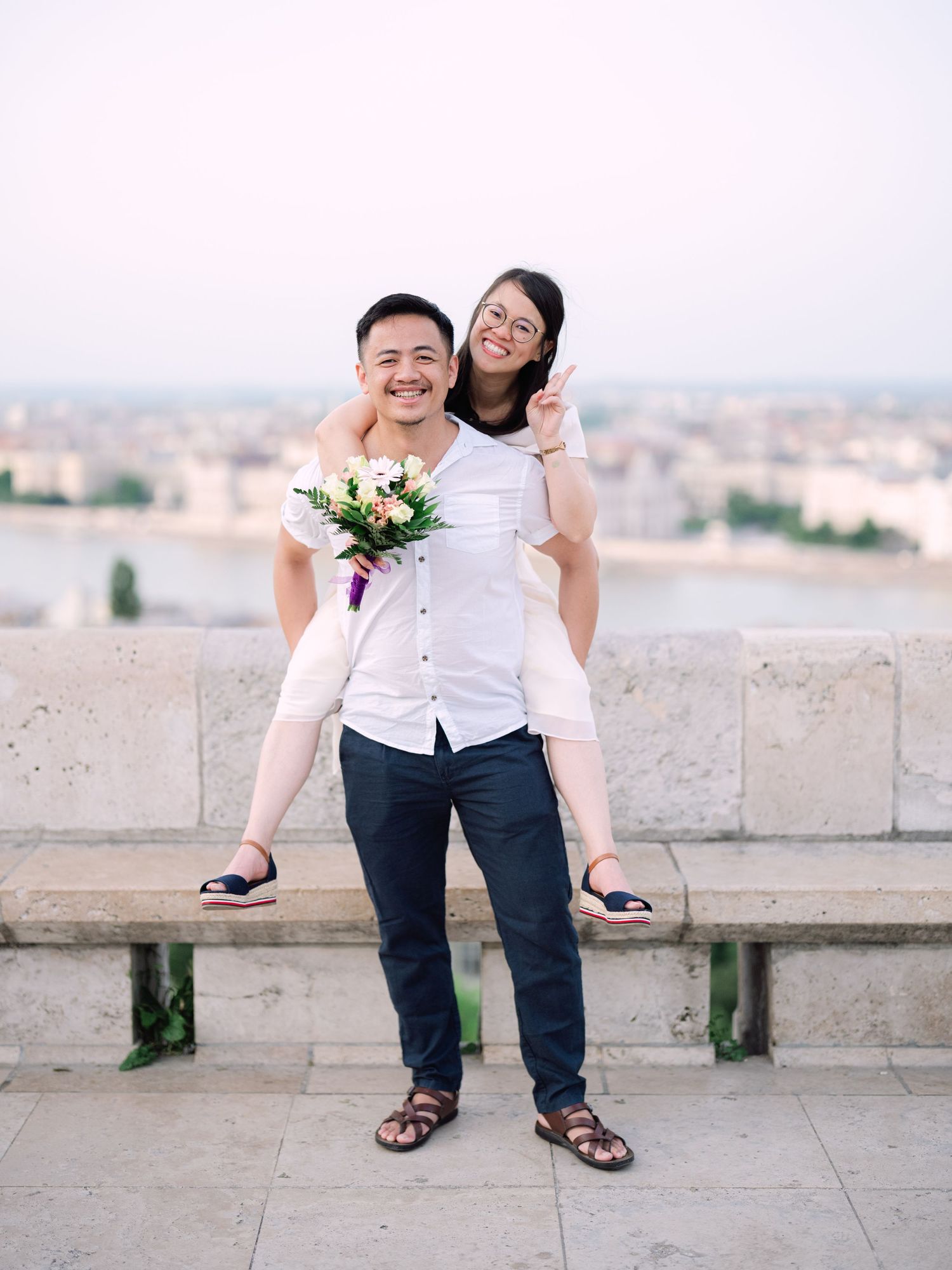 Charming couple posing during a scenic engagement shoot with breathtaking views of Budapest from Fisherman’s Bastion at golden hour