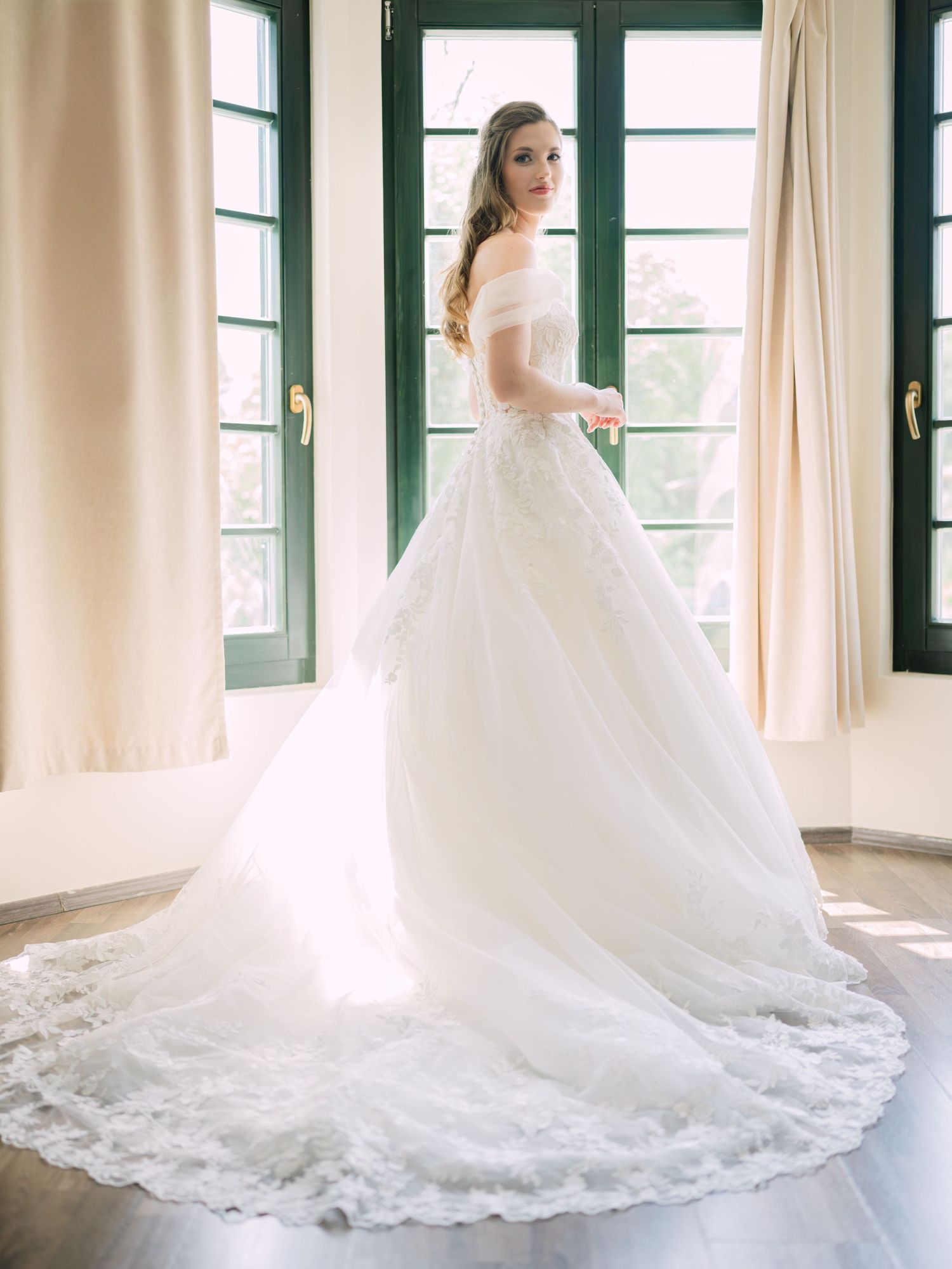 Cheerful bride posing elegantly for a stunning bridal portrait in Budapest, captured during an intimate wedding with timeless charm
