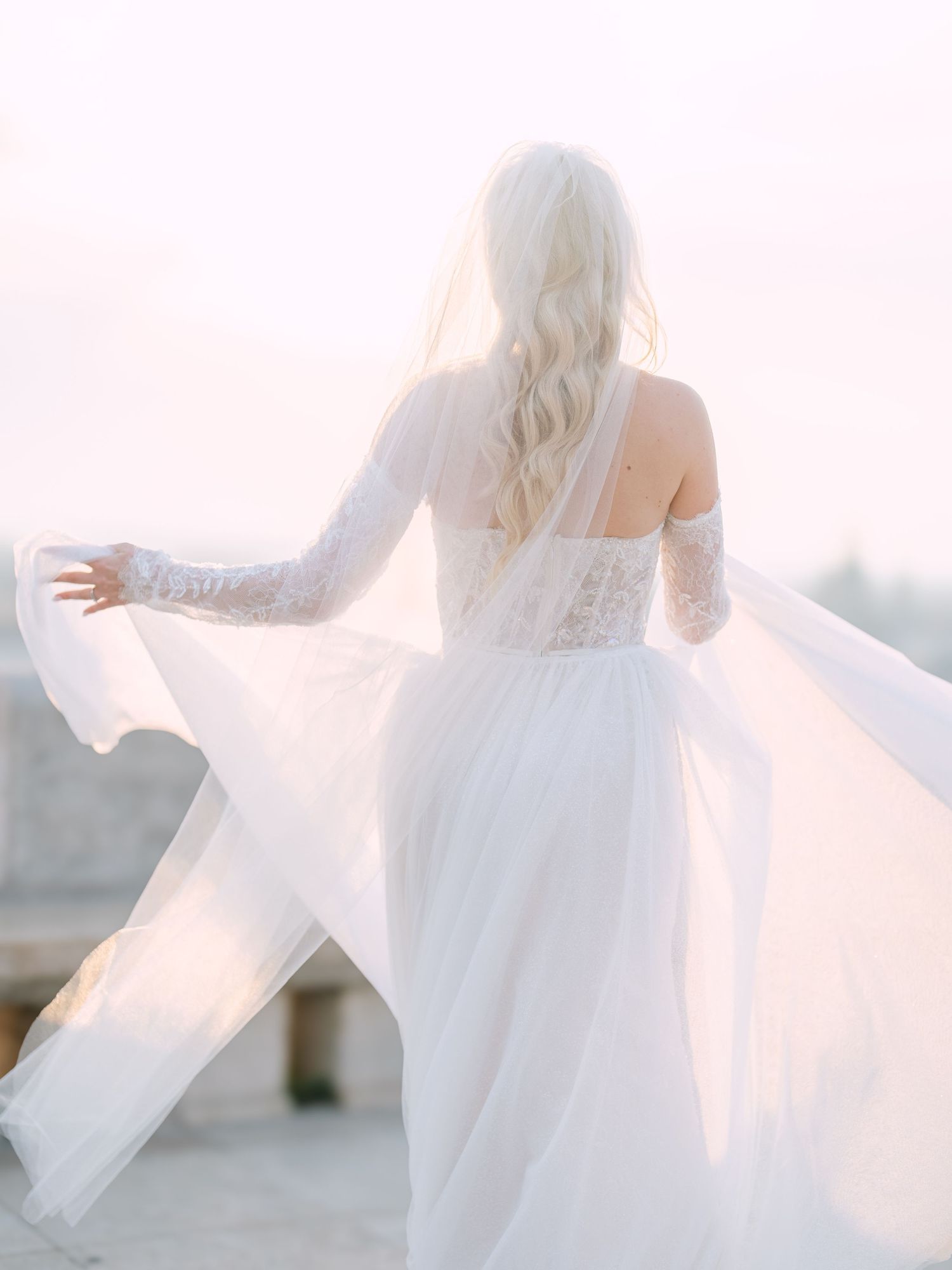 Elegant bride posing gracefully in a La Mariée dress at sunrise on Fisherman’s Bastion in Budapest, captured by Hang Pham Photography