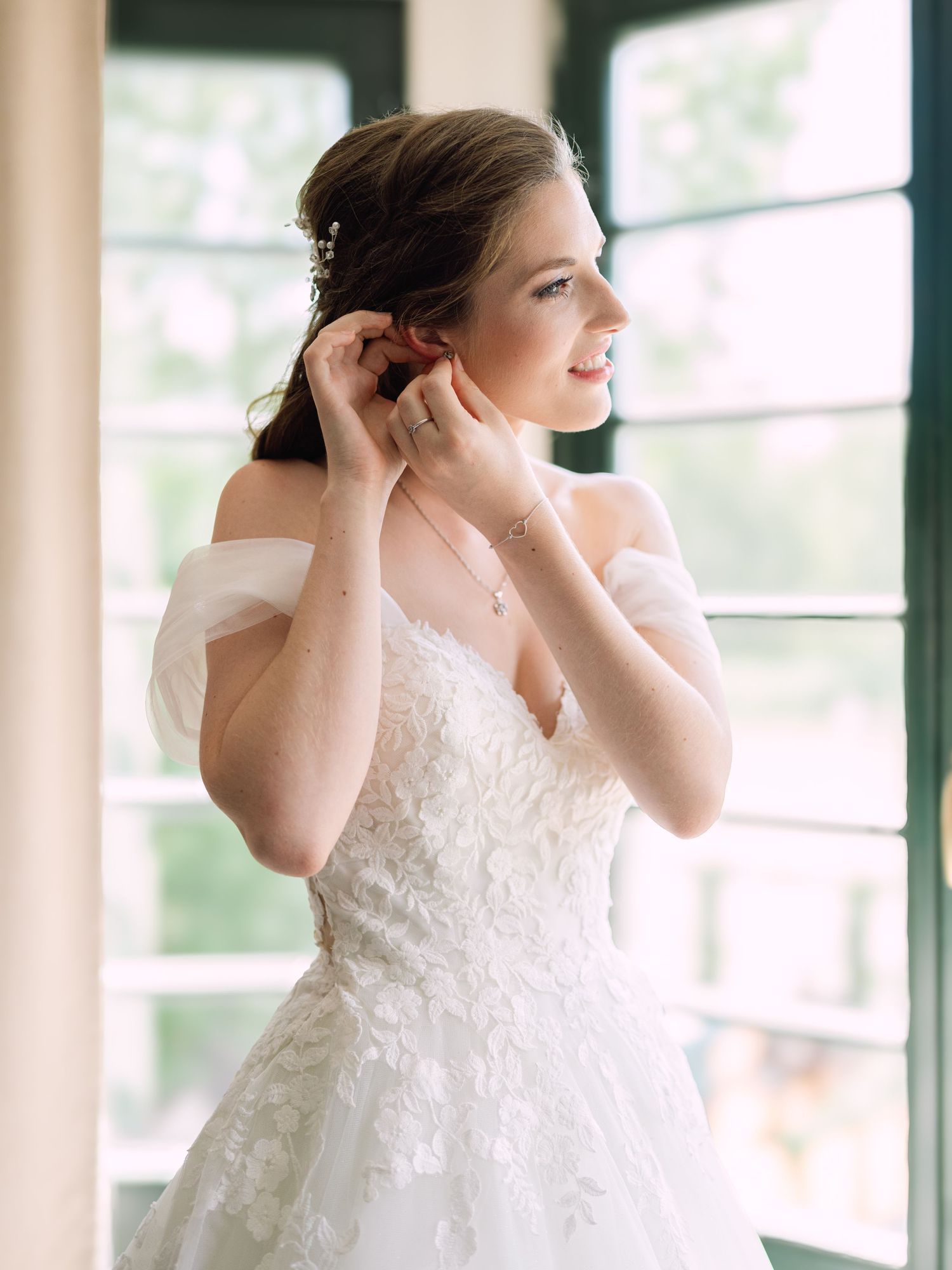 Cheerful bride posing elegantly for a stunning bridal portrait in Budapest, captured during an intimate wedding with timeless charm