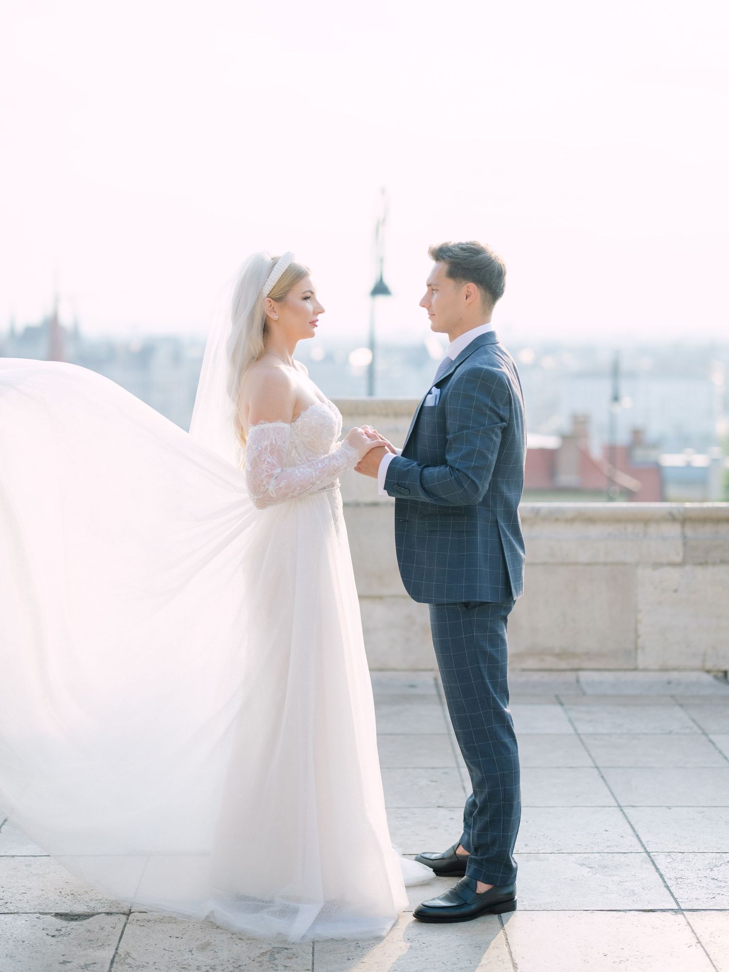 Captivating couple posing at sunrise on Fisherman’s Bastion in Budapest for a pre-wedding session, captured by Hang Pham Photography