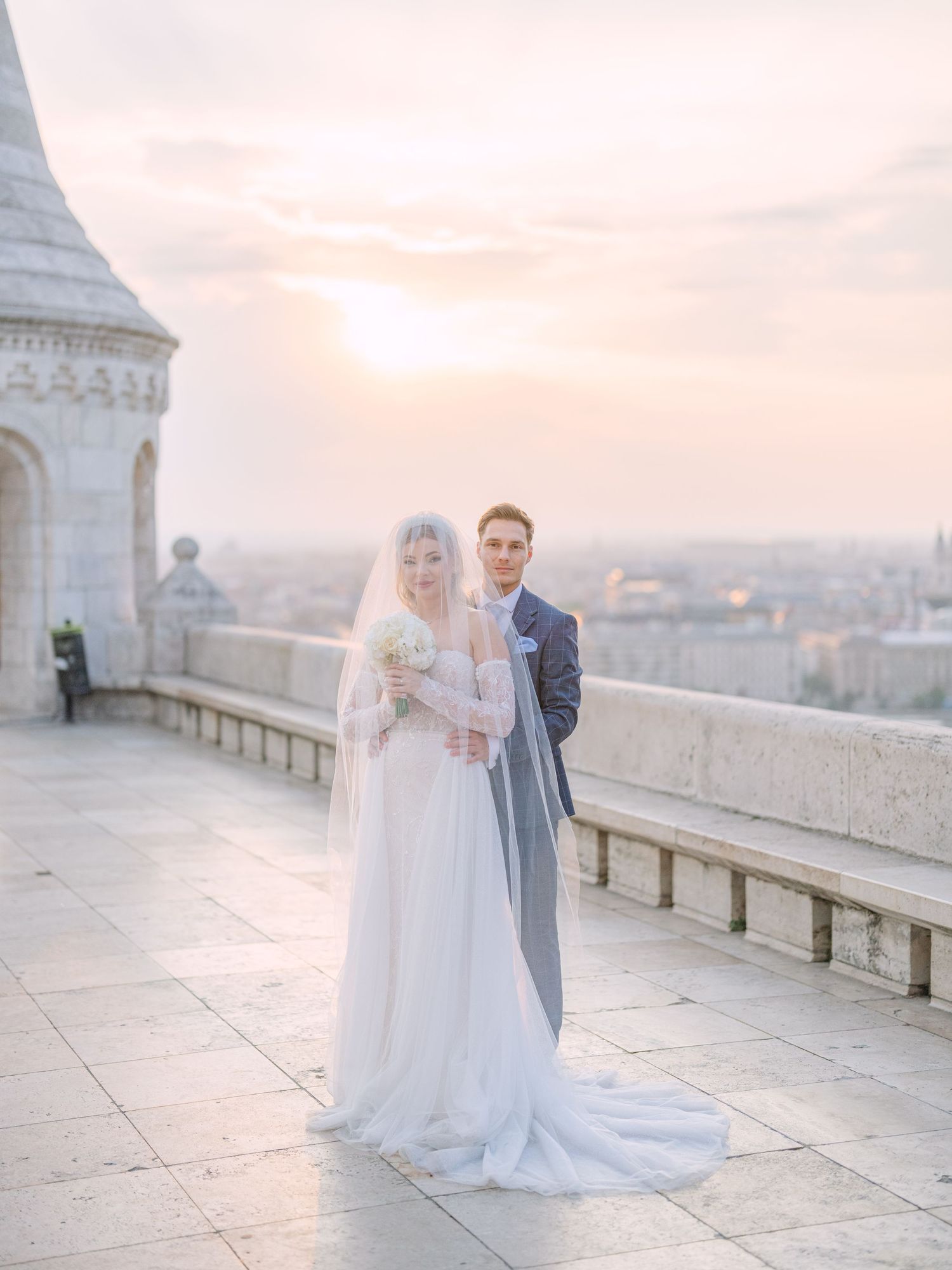 Captivating couple posing at sunrise on Fisherman’s Bastion in Budapest for a pre-wedding session, captured by Hang Pham Photography