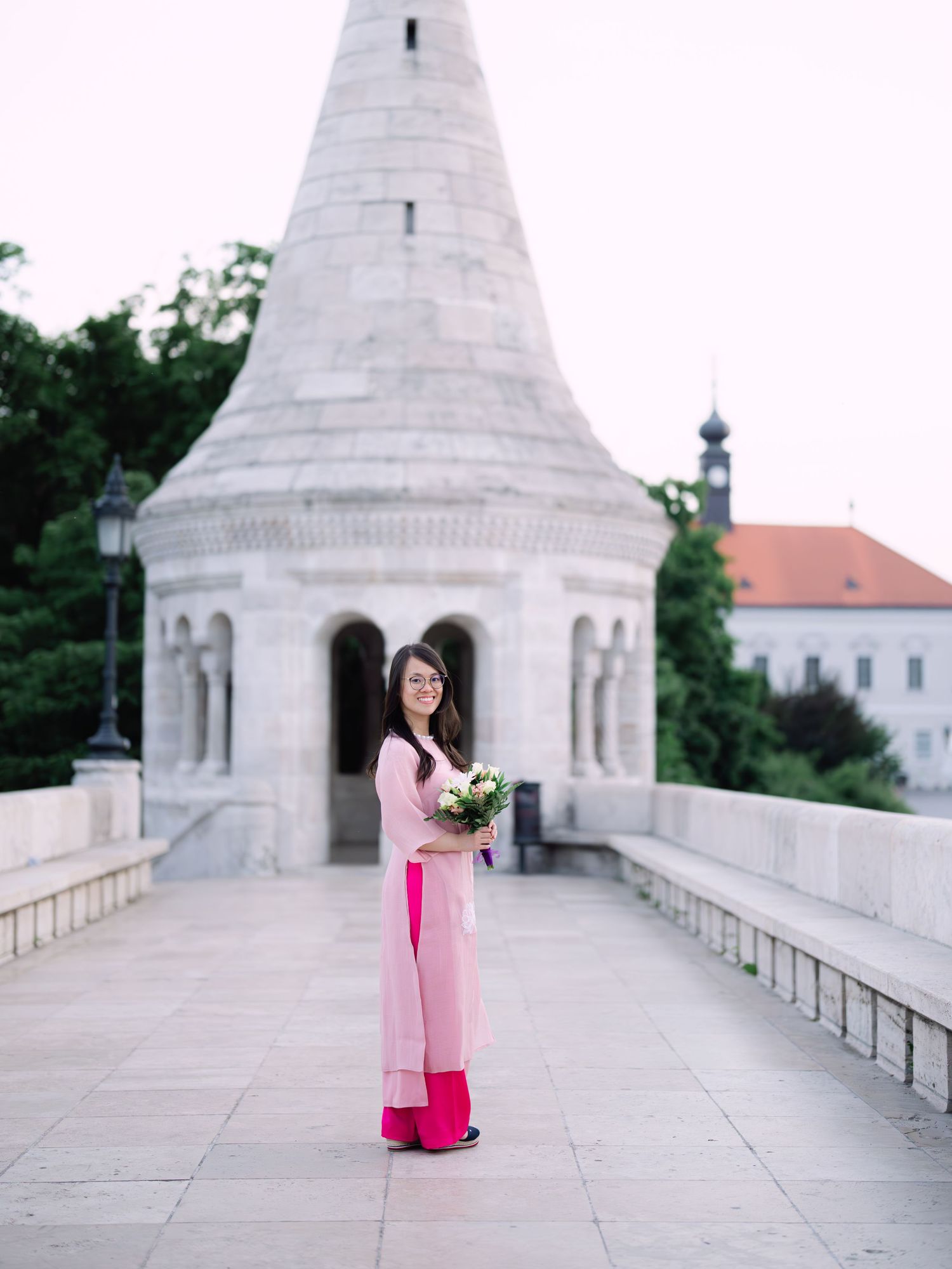 Charming bride posing during a scenic engagement shoot with breathtaking views of Budapest from Fisherman’s Bastion at golden hour
