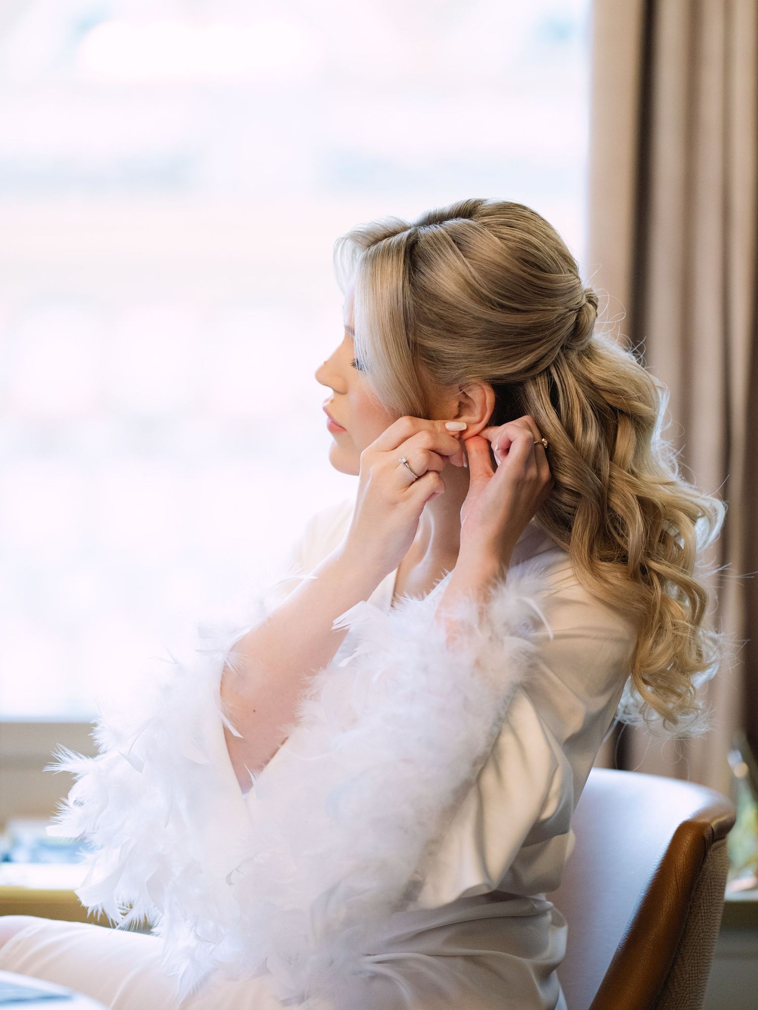 Captivating bride getting ready in a luxurious Hilton Hotel suite in Budapest, preparing for her wedding day with elegance and charm