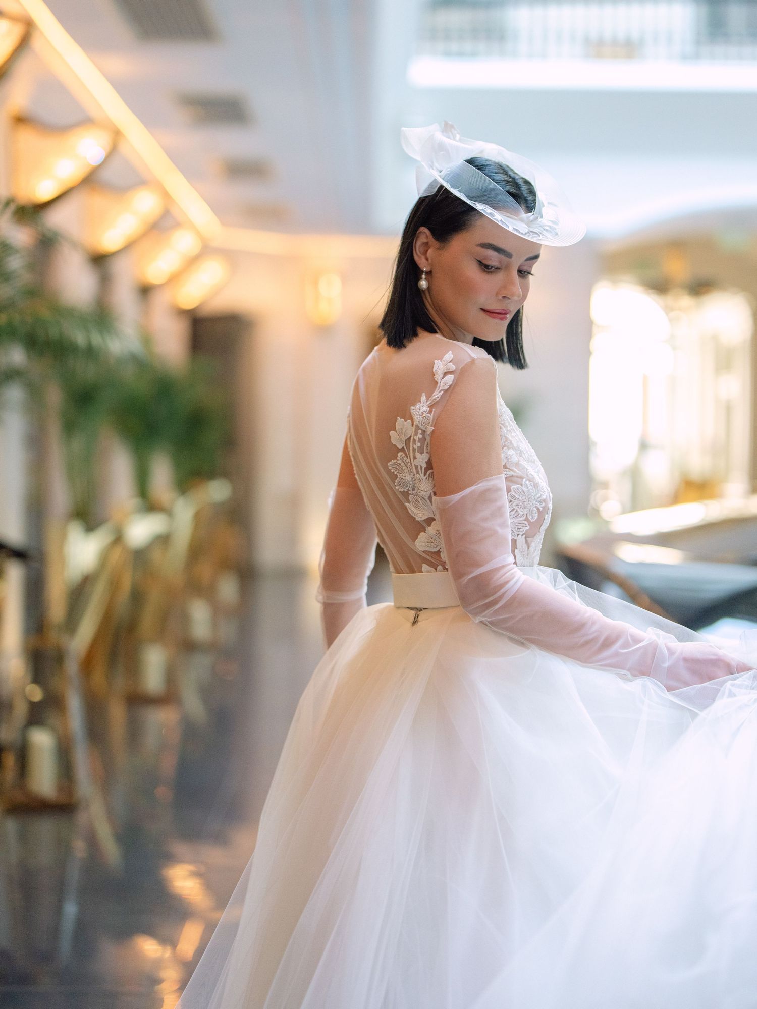 Elegant bride in a Nagy Agota wedding dress posing at Aria Hotel Budapest during a destination wedding editorial, captured by Hang Pham