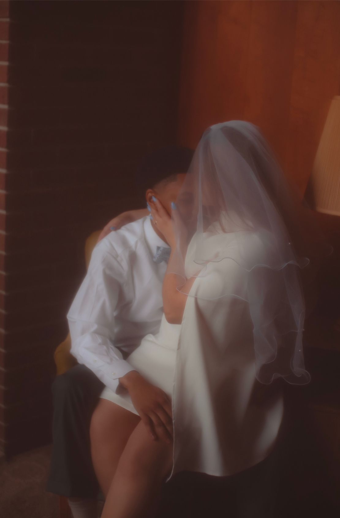 Wedding photo in soft-focus, artistic photo with warm lighting and moody atmosphere.