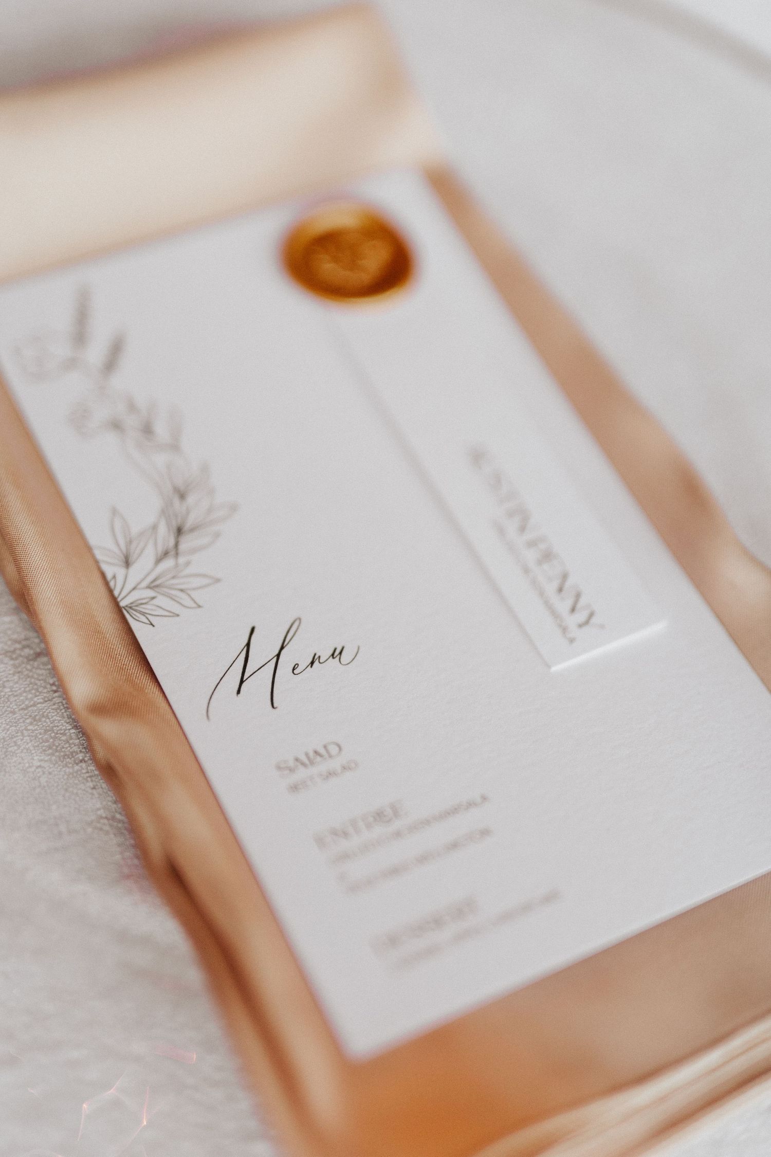 Elegant wedding menu cards with minimalist design and wax seals.