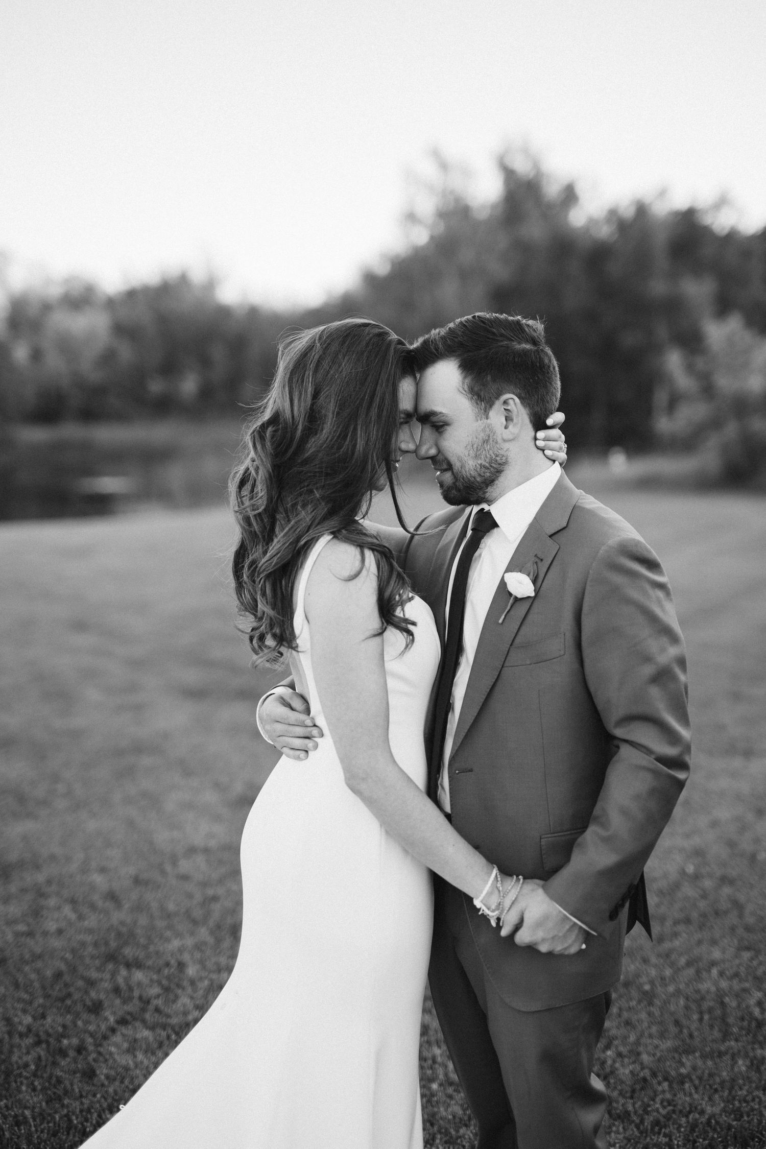 Intimate black and white portrait of newlyweds sharing romantic moment.