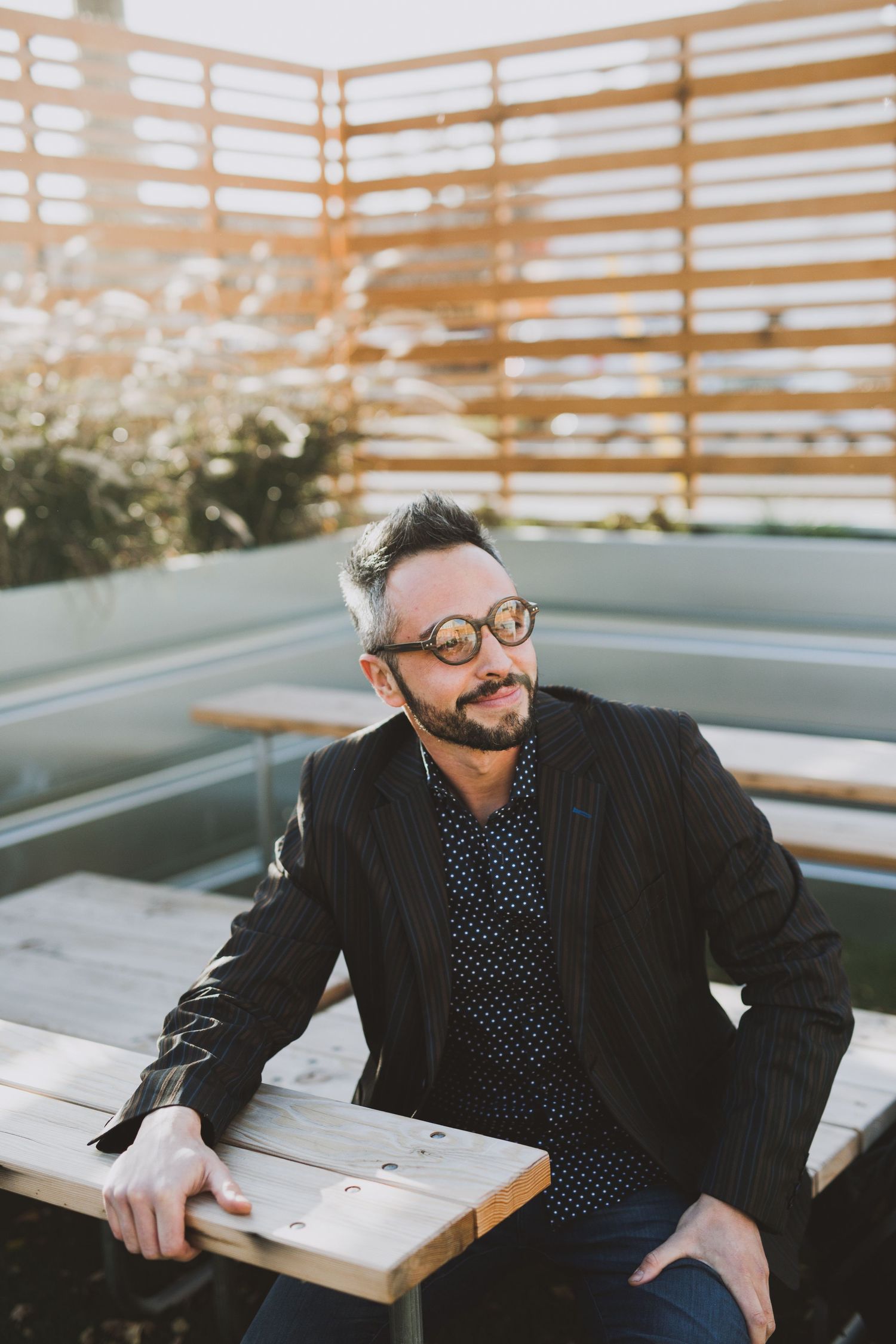 Professional headshot series against wooden slat backdrop at sunset.