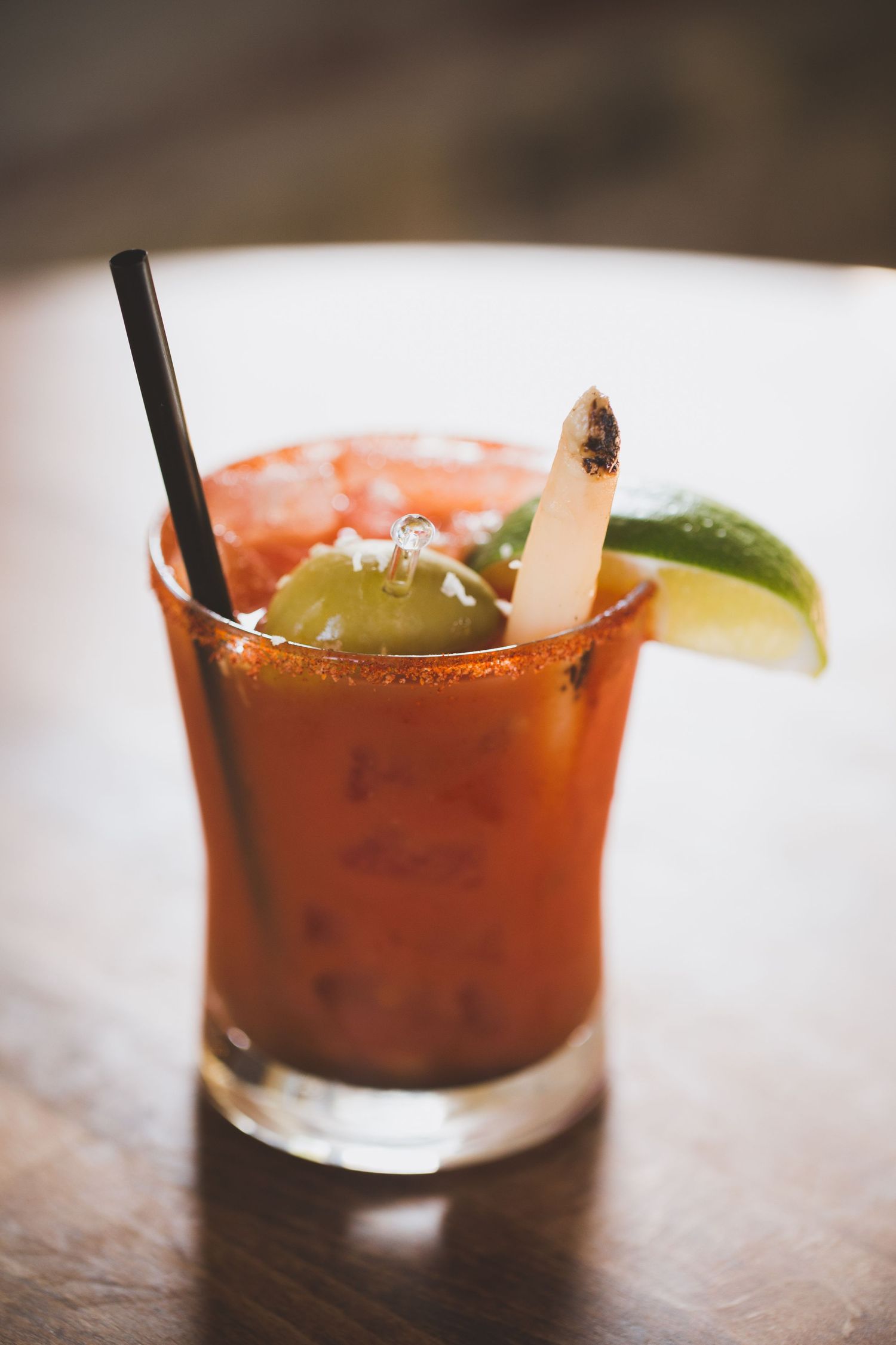 Close-up sequence of Bloody Mary cocktails garnished with lime and celery.