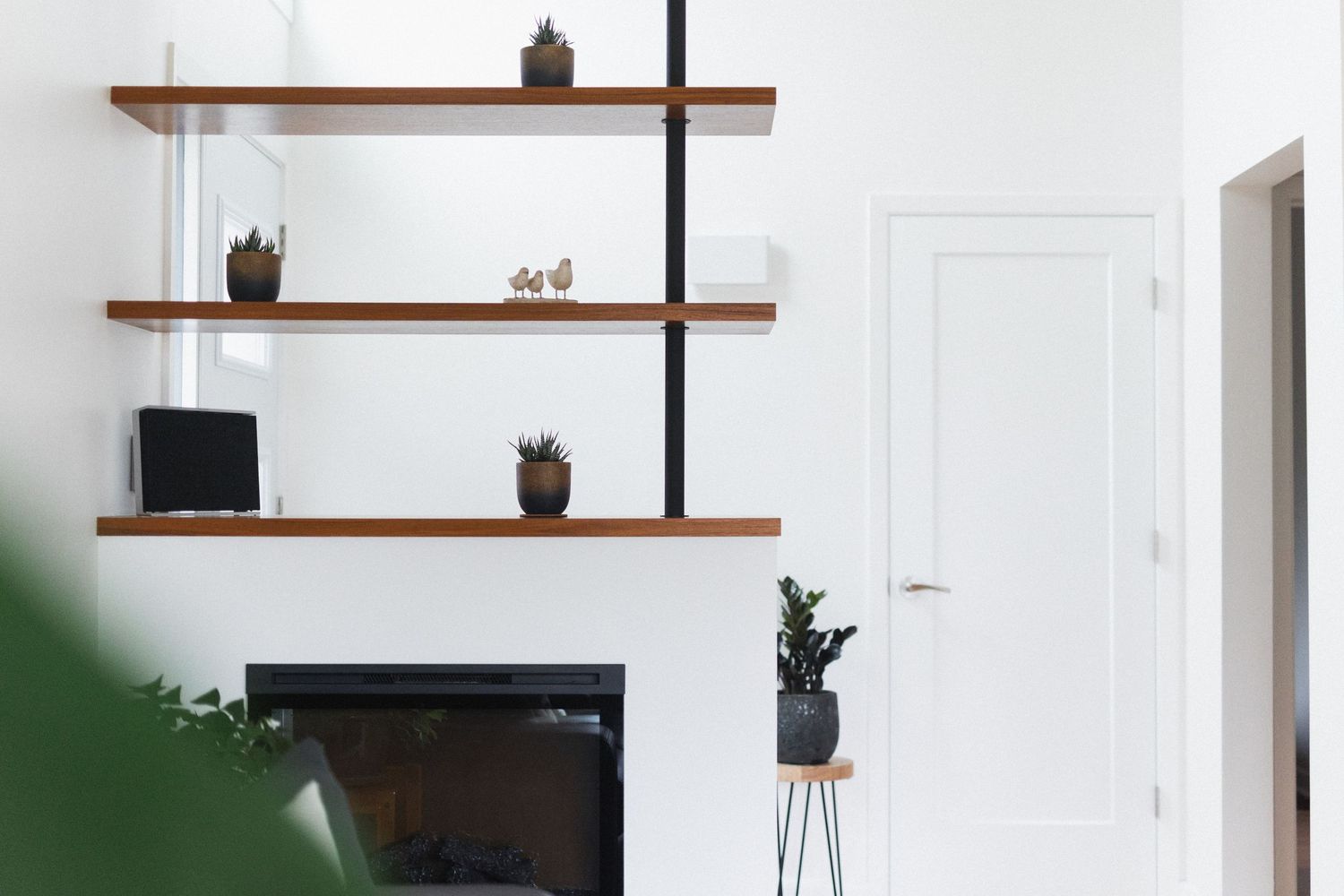 Wooden shelving display with decorative items and storage in a modern apartment interior.