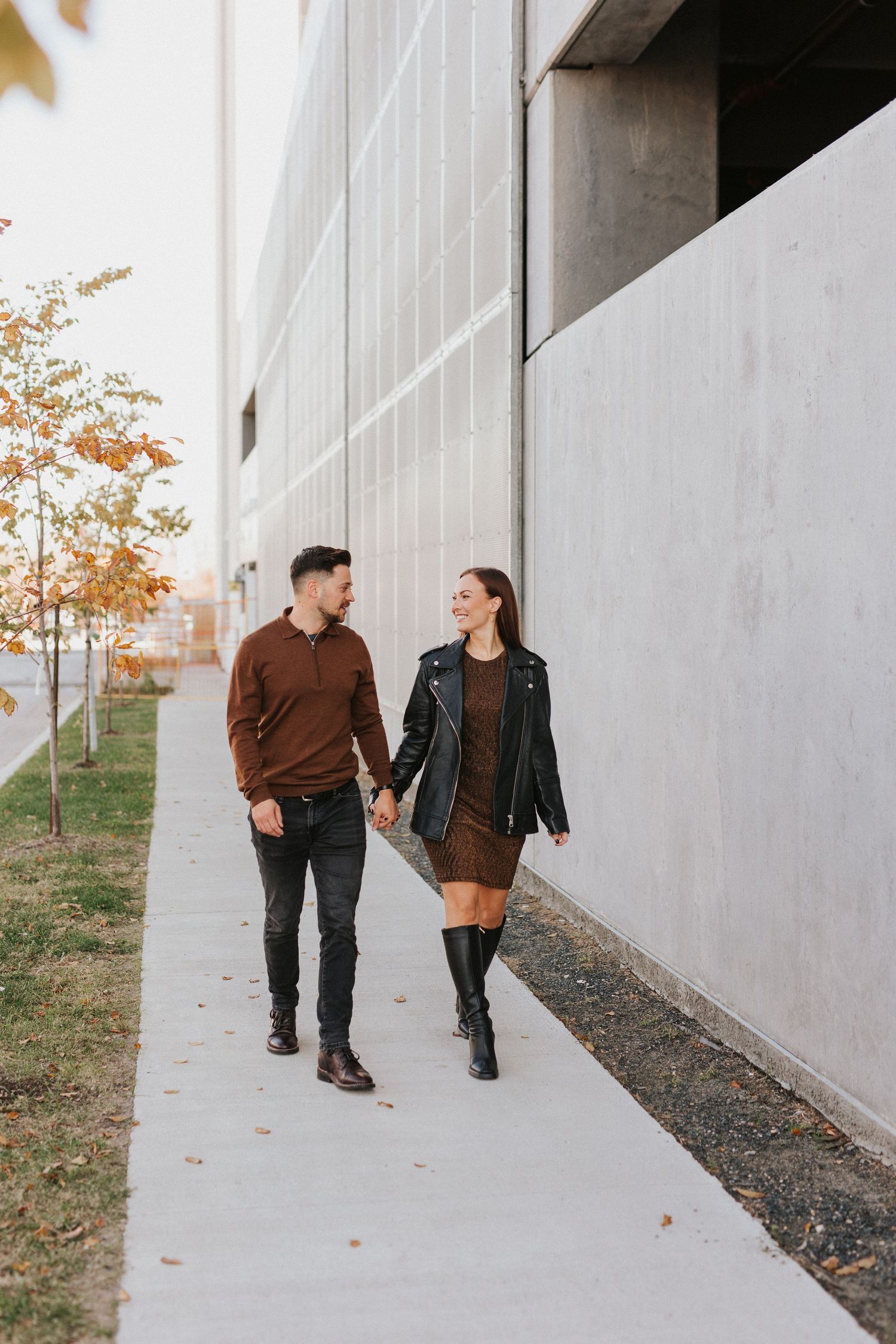 Candid walking shots along a concrete wall during fall season.