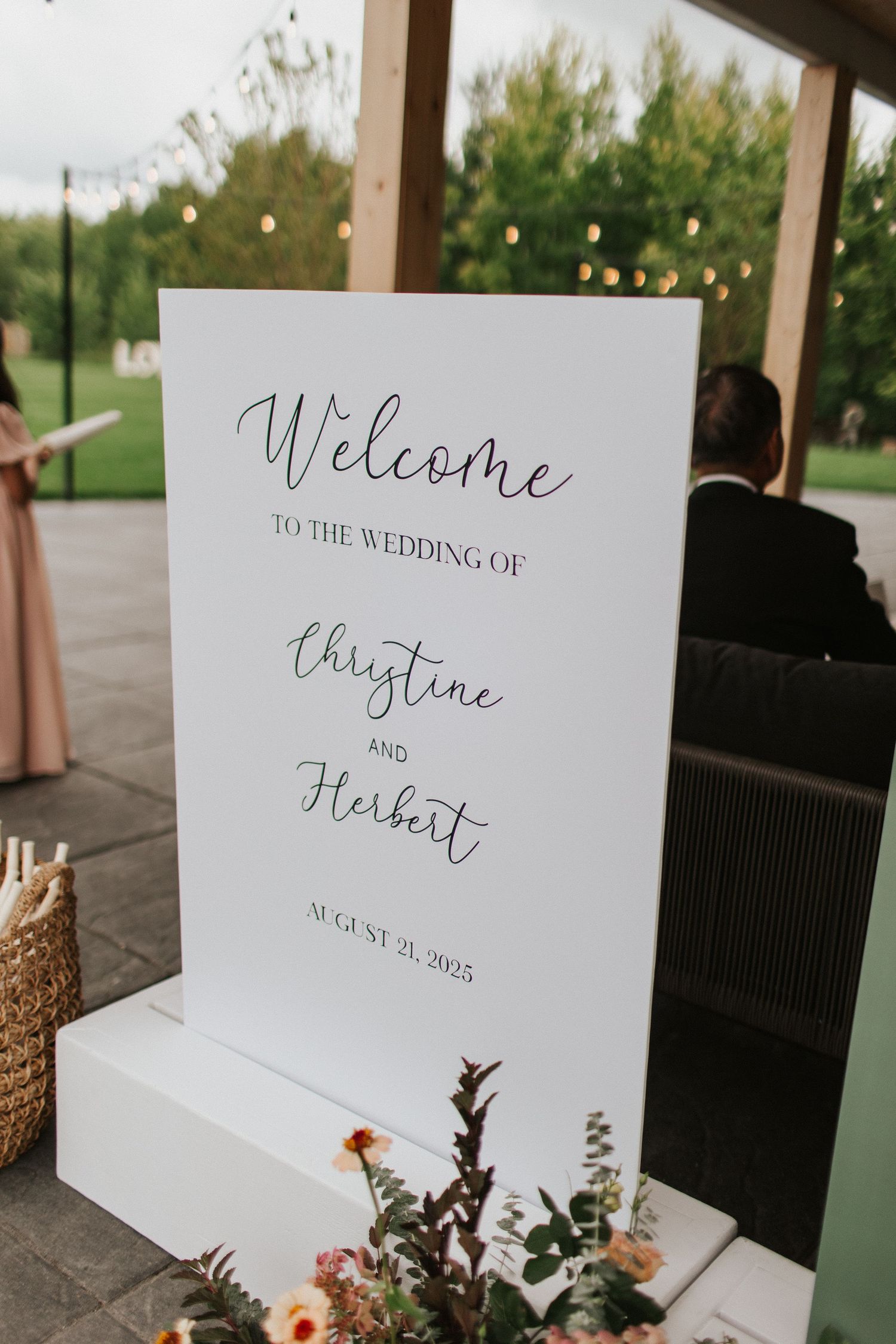 Elegant wedding welcome signs with calligraphy displayed on white paper with floral decorations.