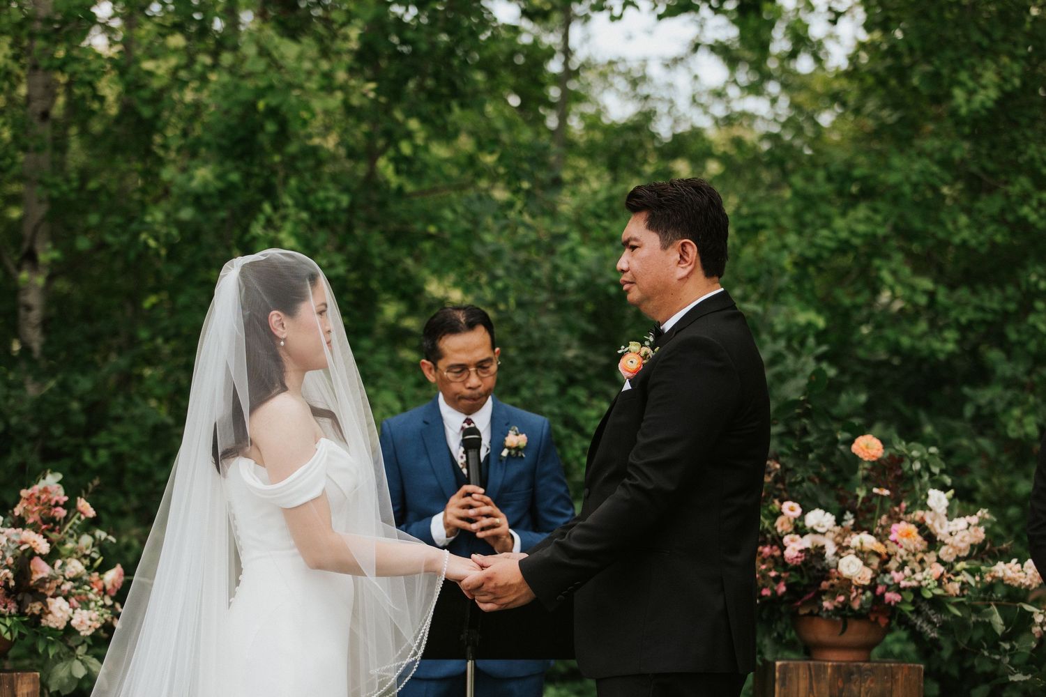 Wedding party celebrates in a lush garden setting with elegant floral arrangements and romantic ambiance.