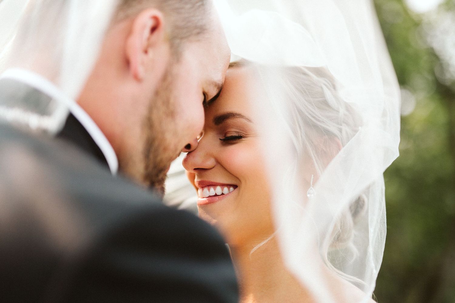 An intimate wedding moment captured in soft natural light outdoors.
