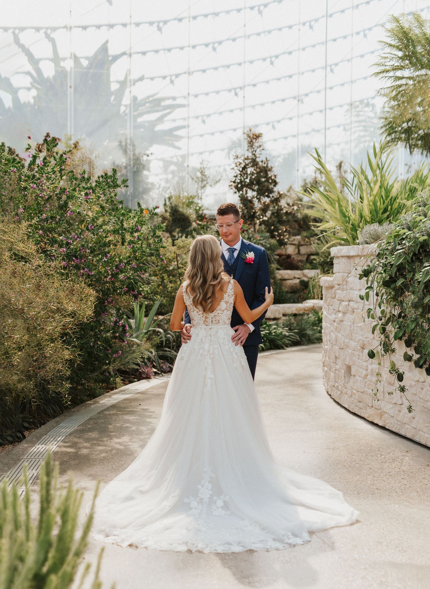 Outdoor wedding venue with string lights and stone walls creating a romantic atmosphere.