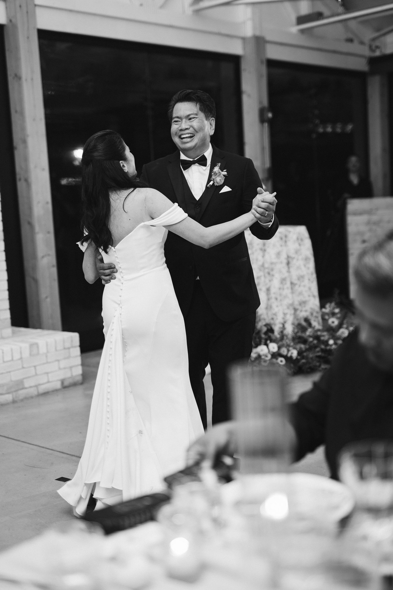 Wedding reception candid moments captured in black and white photography.