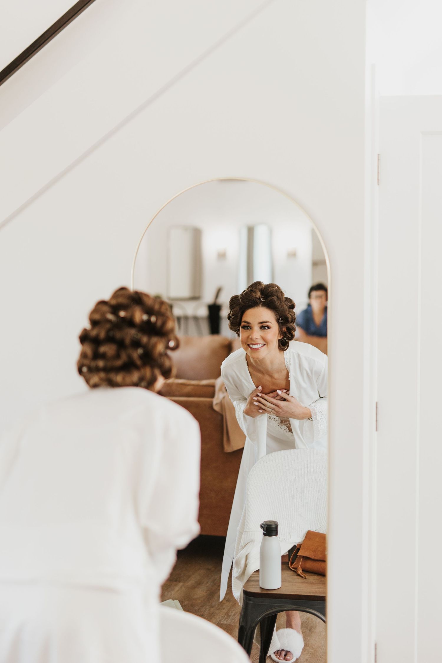 Getting ready moments captured in a bright white modern space.