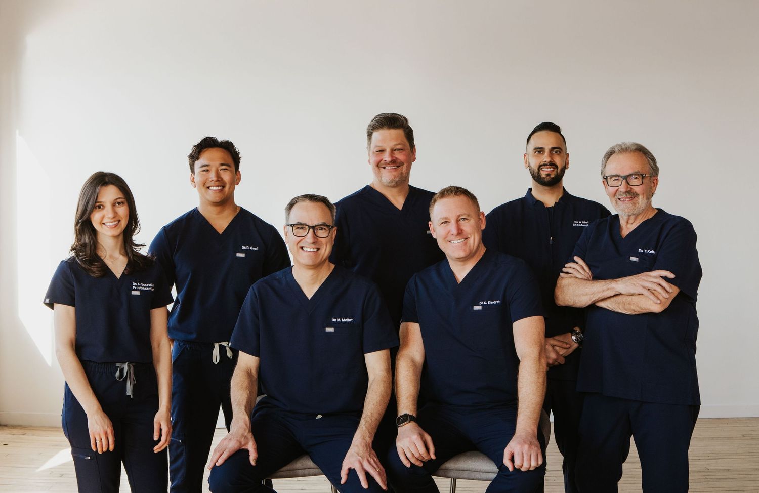 Medical team members in navy scrubs lined up for a group photo.